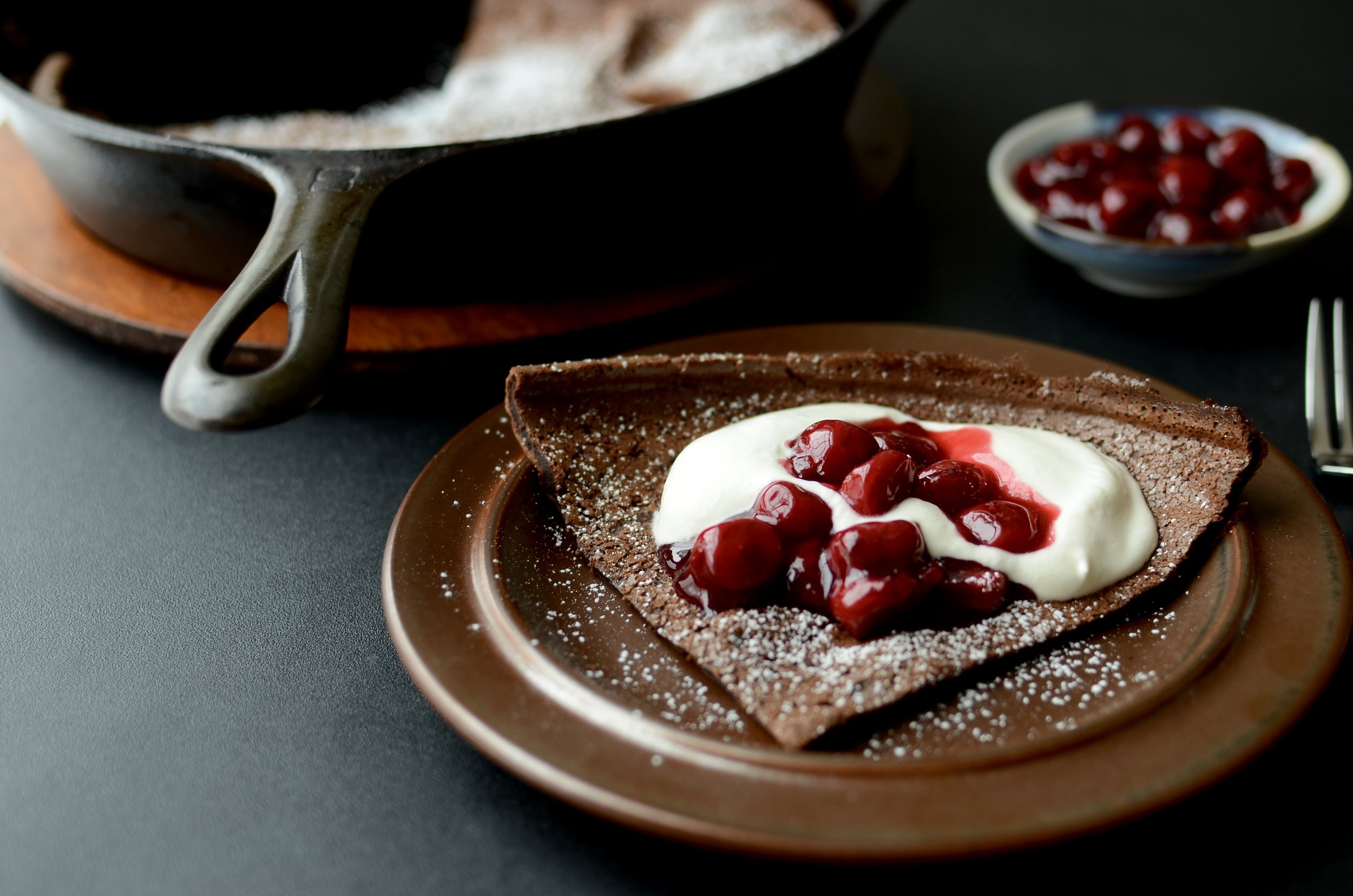 Black Forest Dutch Baby - ButterYum. how to make a chocolate dutch baby. Chocolate dutch baby recipe. chocolate German pancake recipe. recipe for dutch baby or German pancake. Black Forest desserts that aren’t cake.