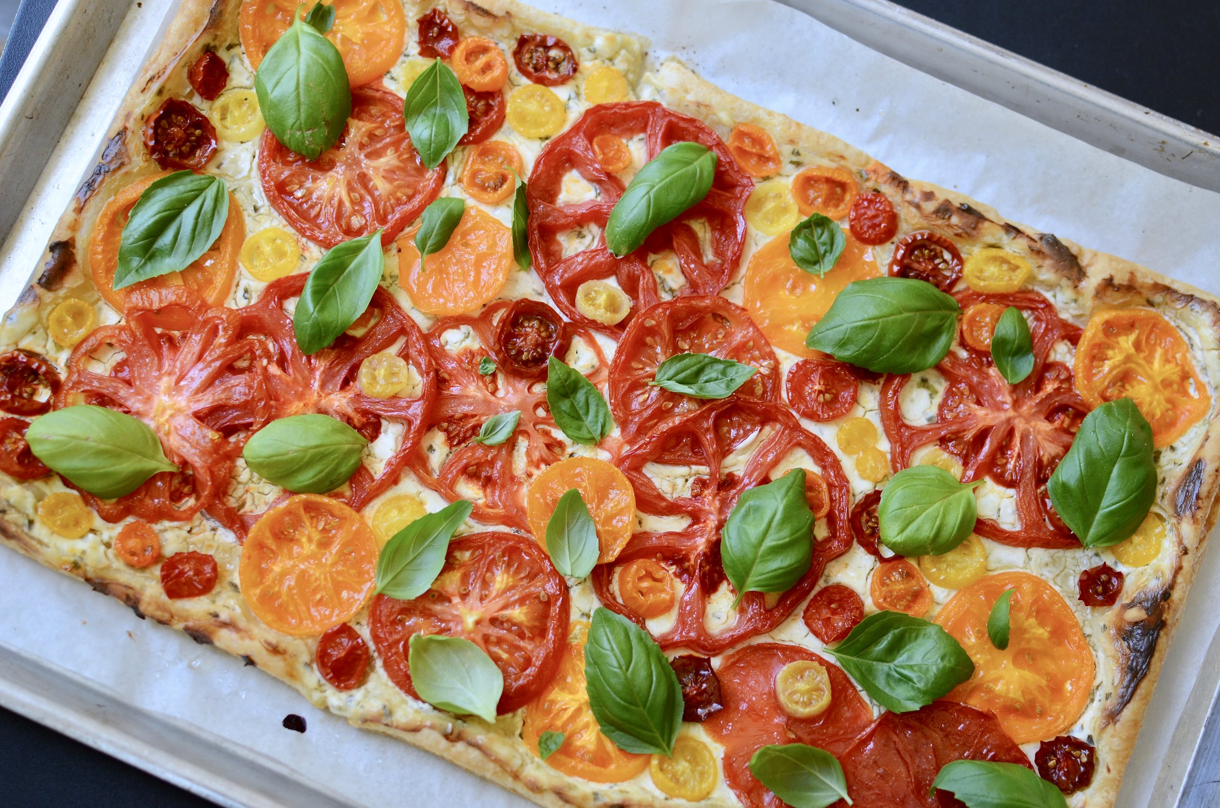 Heirloom Tomato Tart - ButterYum. CSA tomatoes. what to do with yellow orange tomatoes. cooking with heirloom tomatoes. heirloom tomato recipes. French tomato tart. Italian tomato tart. farmer’s market tomatoes. tomato basil tart. heirloom tomato recipe ideas. garden tomato recipes. what to do with all those tomatoes. bumper crop tomato ideas.