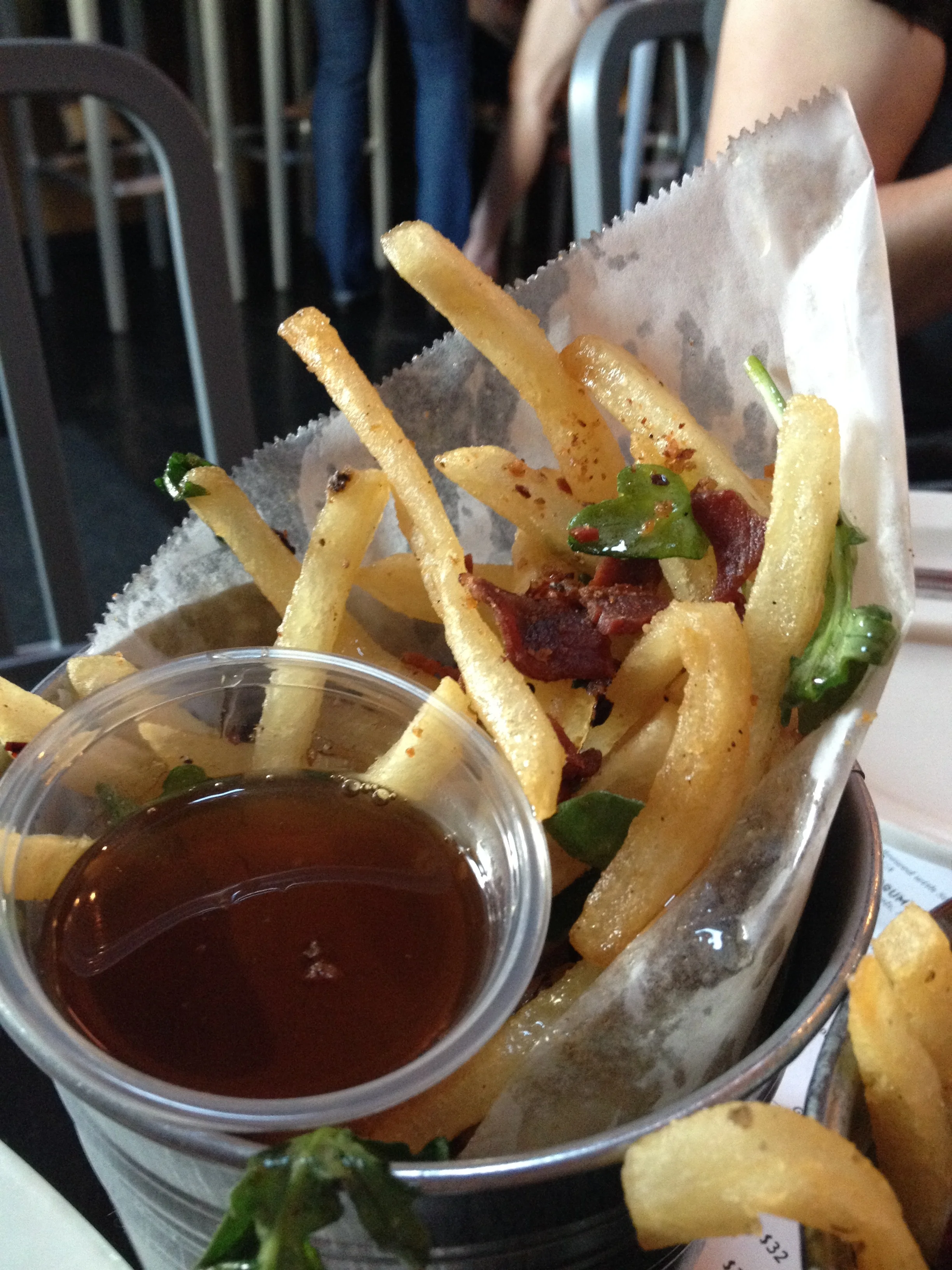Bacon Fat Fries with fried bacon bits, wild arugula, chili morita, and maple vinegar dip