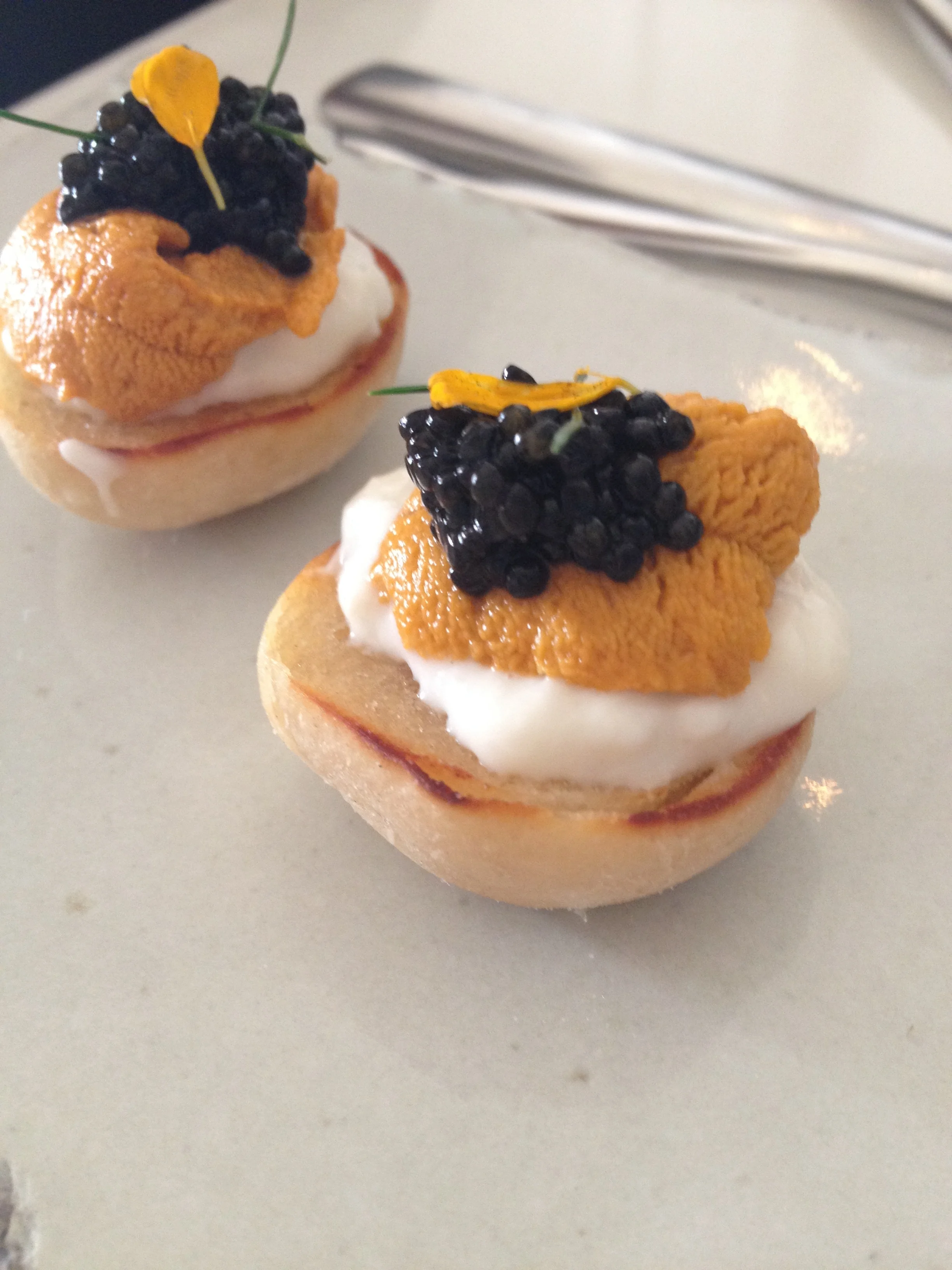 English muffin with uni, crème fraiche, and caviar.
