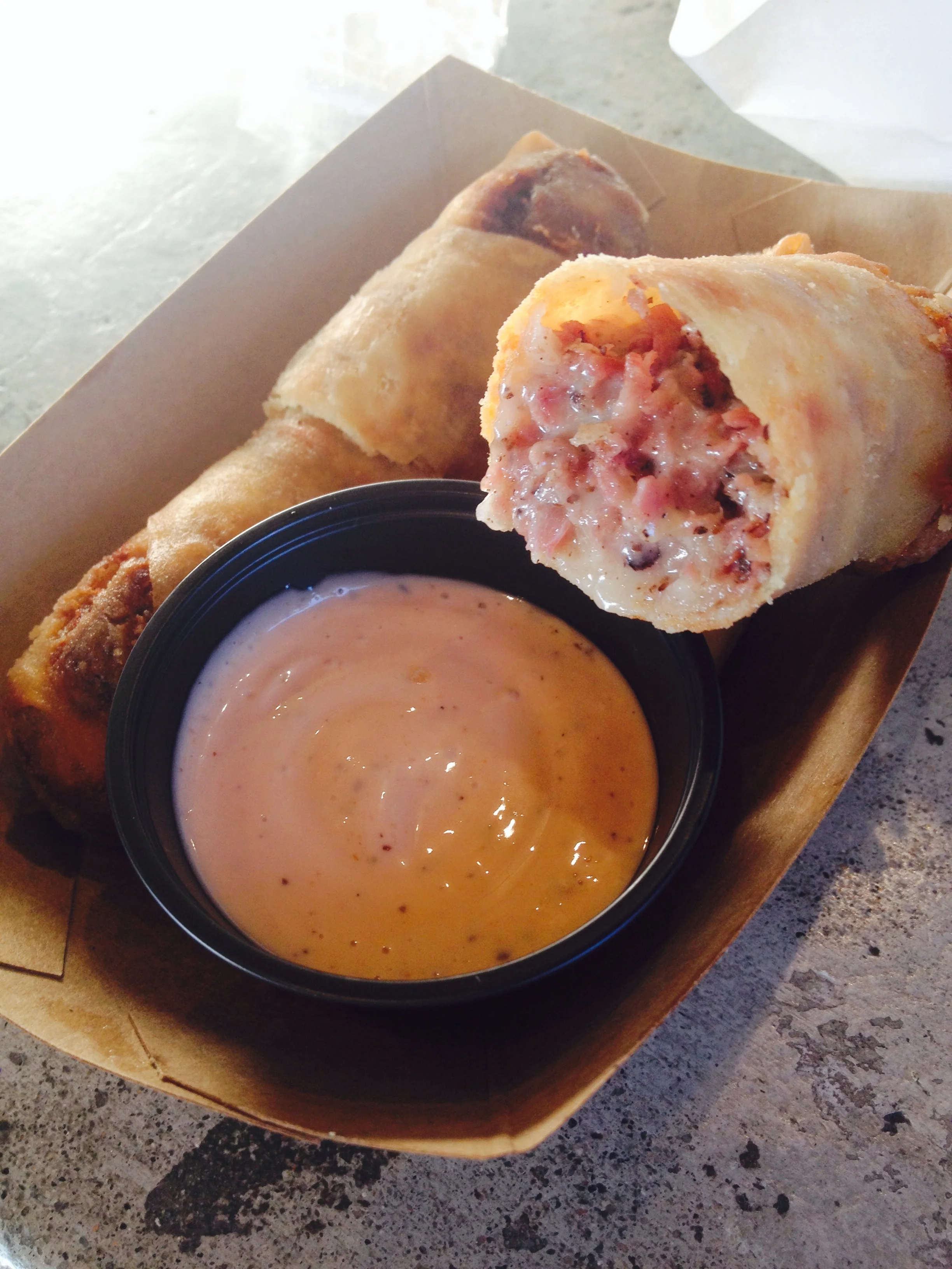 Pastrami Ruben Rolls with hot pastrami, swiss, sauerkraut, stuffed in a crispy spring roll wrapper with Russian dressing.