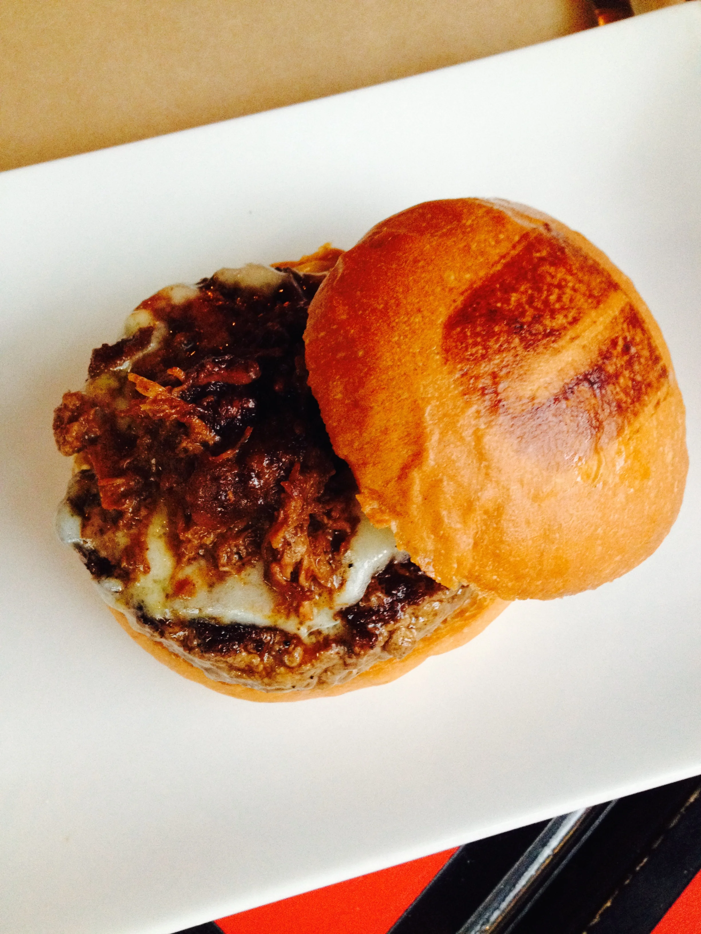 The Royale Burger with a beef patty topped with braised short rib, truffled aioli & truffle cheese.