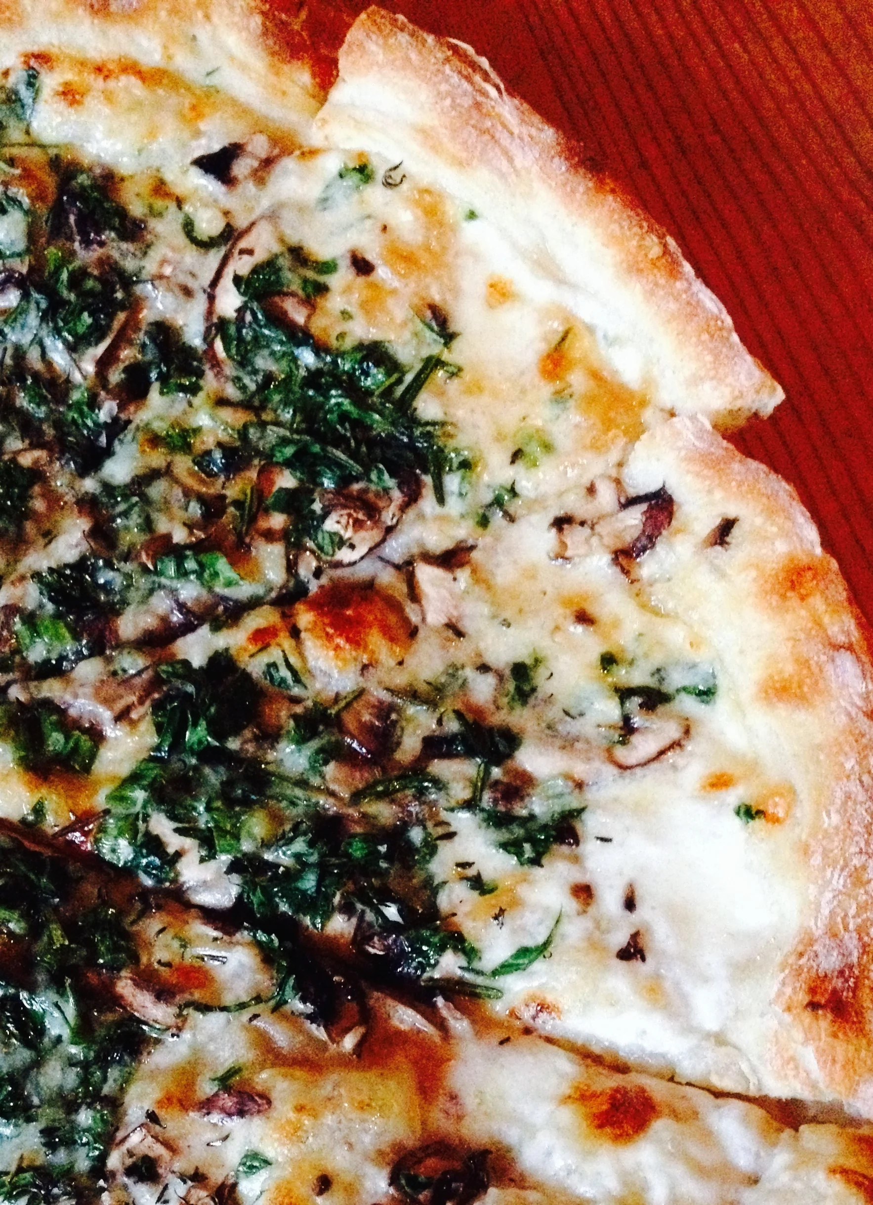 Shaved Mushroom Pizza with gruyère, melted onions, black truffle, torn parsley, rosemary, and thyme.