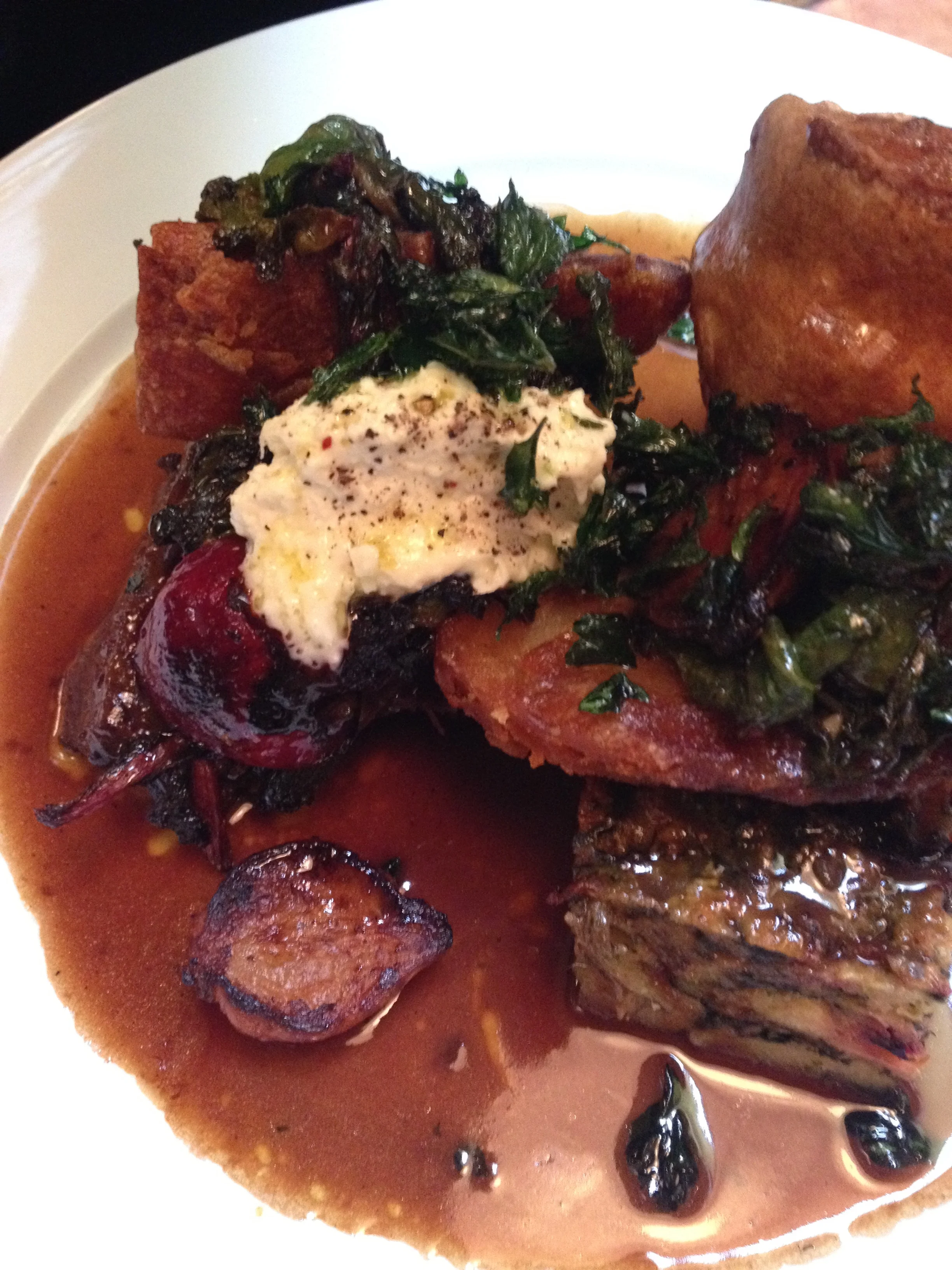 Sunday Roast Slow-Roasted Short Rib with Beets & Horseradish Cream, accompanied by stuffing, roasted potatoes, Yorkshire pudding, and gravy.