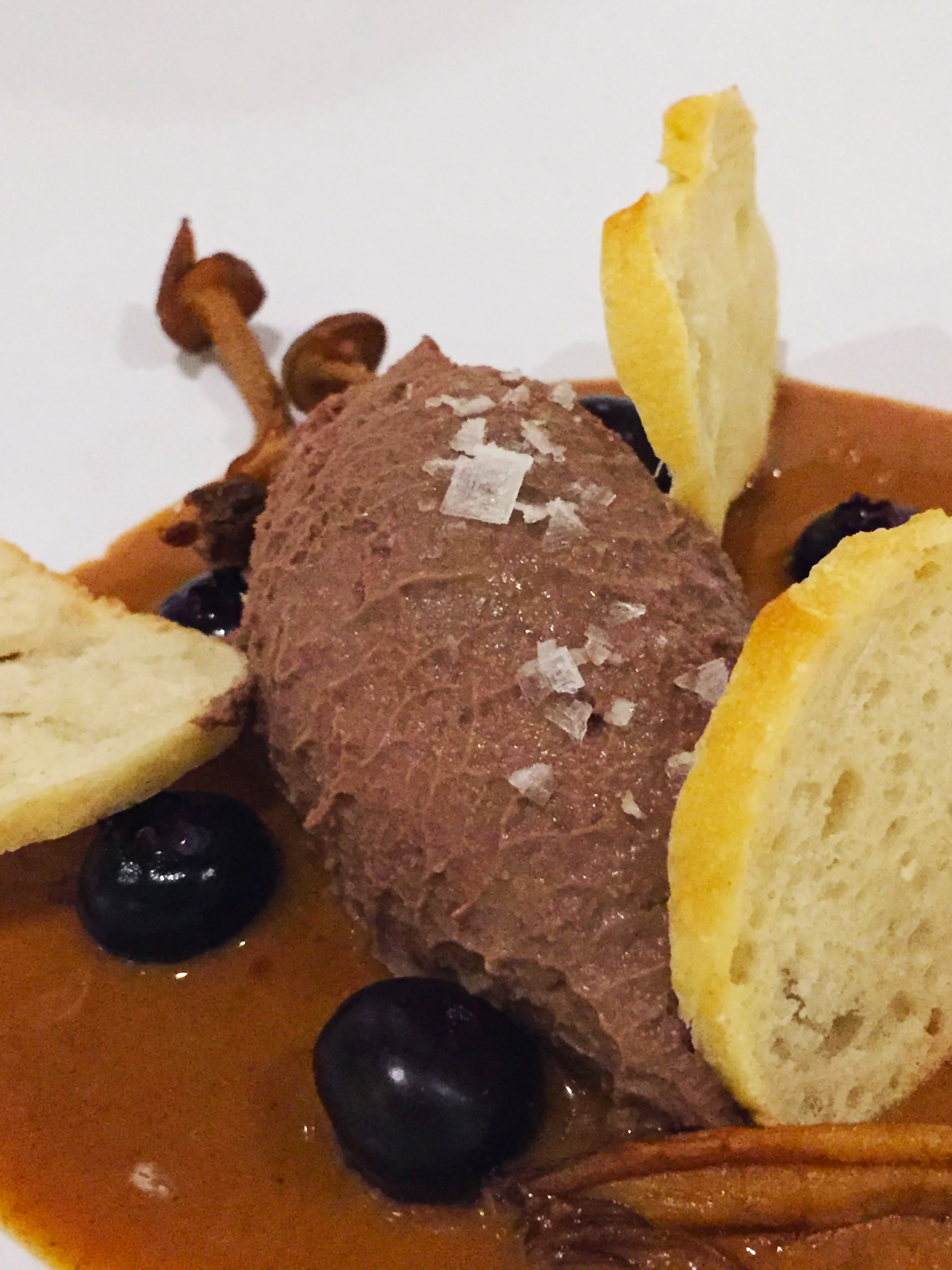 Chicken liver mousse with mushroom, hazelnut praline, pickled blueberries and toast.