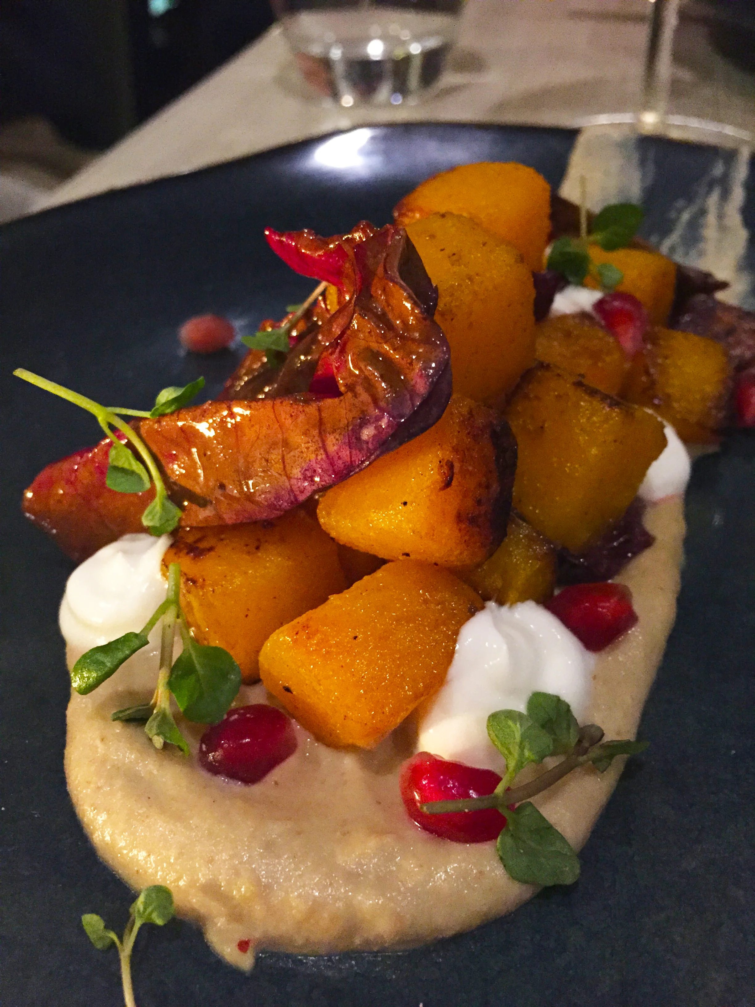 Roasted winter squash with treviso, white chocolate mole, pomegranate and mint.