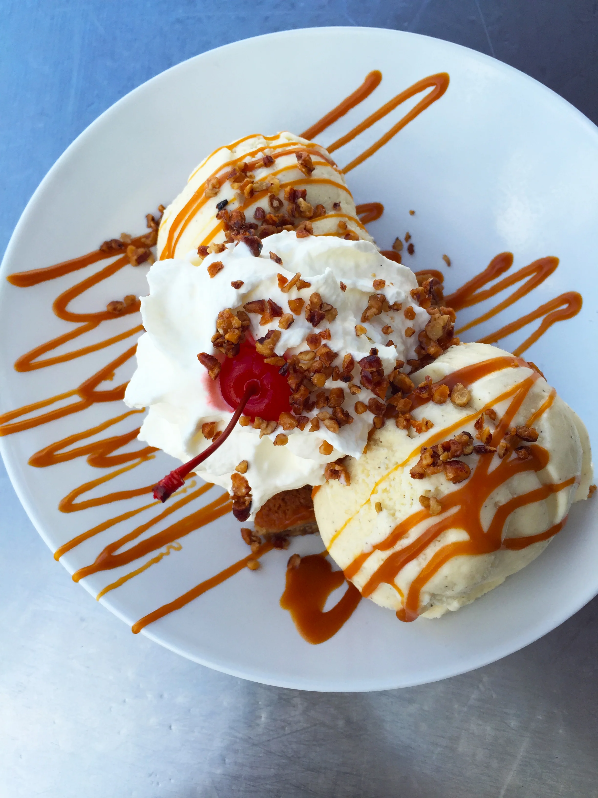 "The Blondie" with a white chocolate blondie, vanilla ice cream, butterscotch, and pecan praline.