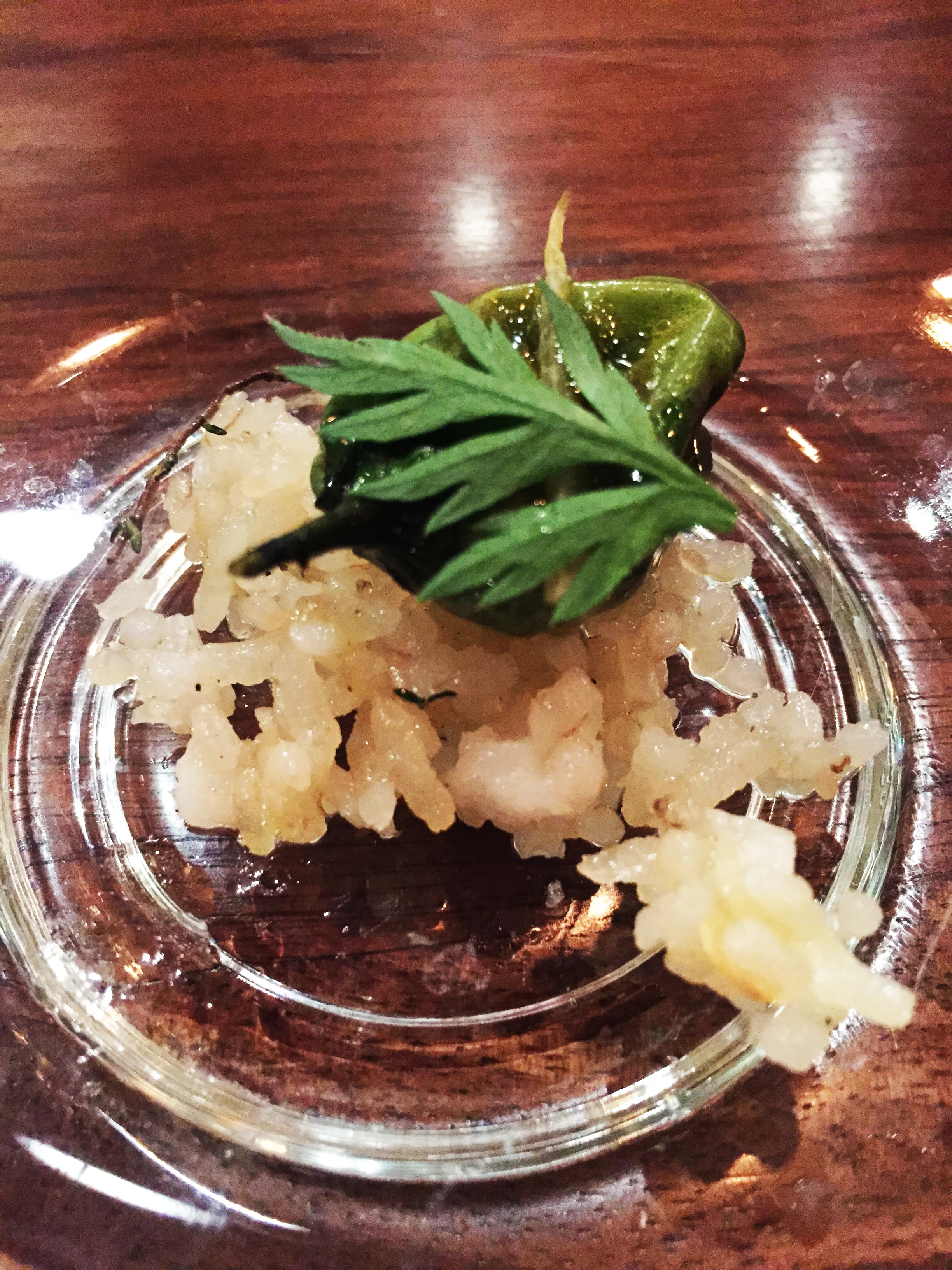 Amuse-Bouche (according to the menu, "something amusing...." of c rispy rice with vinaigrette, lemon zest, shishito pepper, and a carrot top.