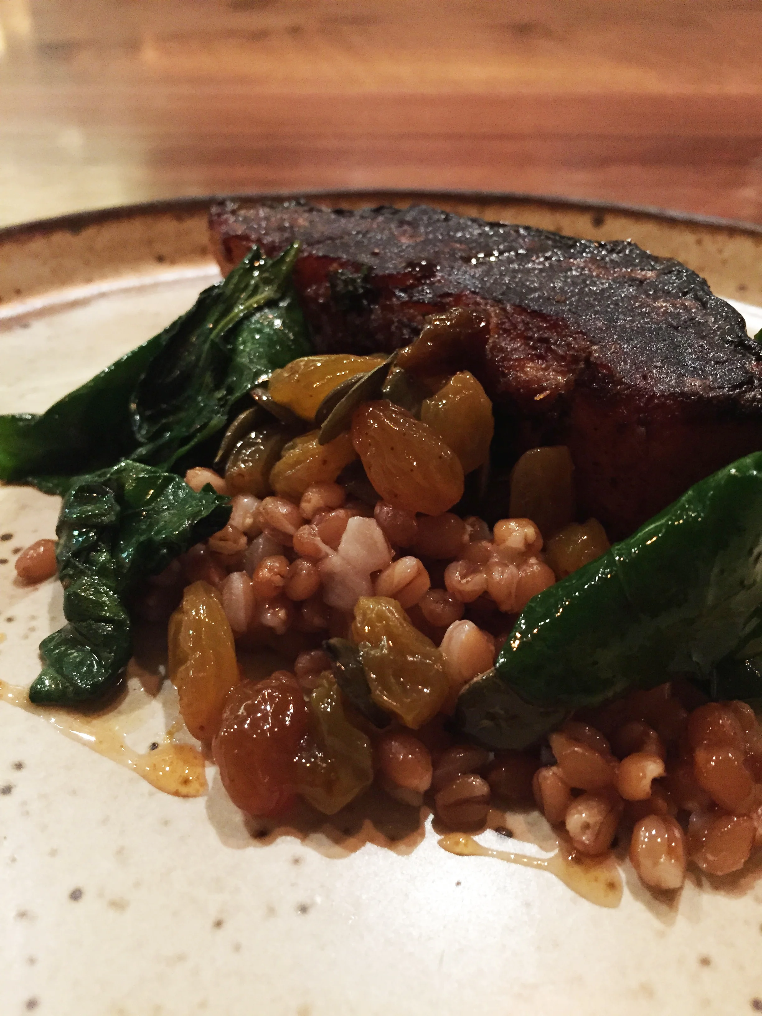 Tranche of Roasted Blue Hubbard Squash, Wheat Berries, Preserved Blueberries, and Pumpkin Seeds.