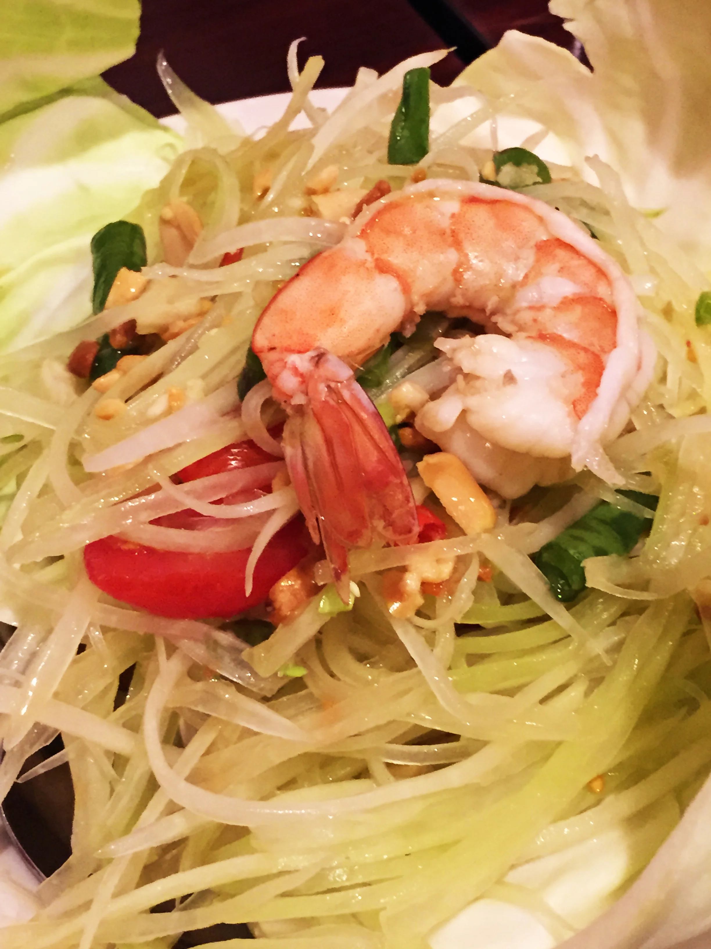 SOM TUM - PAPAYA SALAD - Julienne of green papaya with Thai Style flavor, mixed with garlic, Thai chilies, tomatoes, dried shrimp, ground peanuts and lime juice.