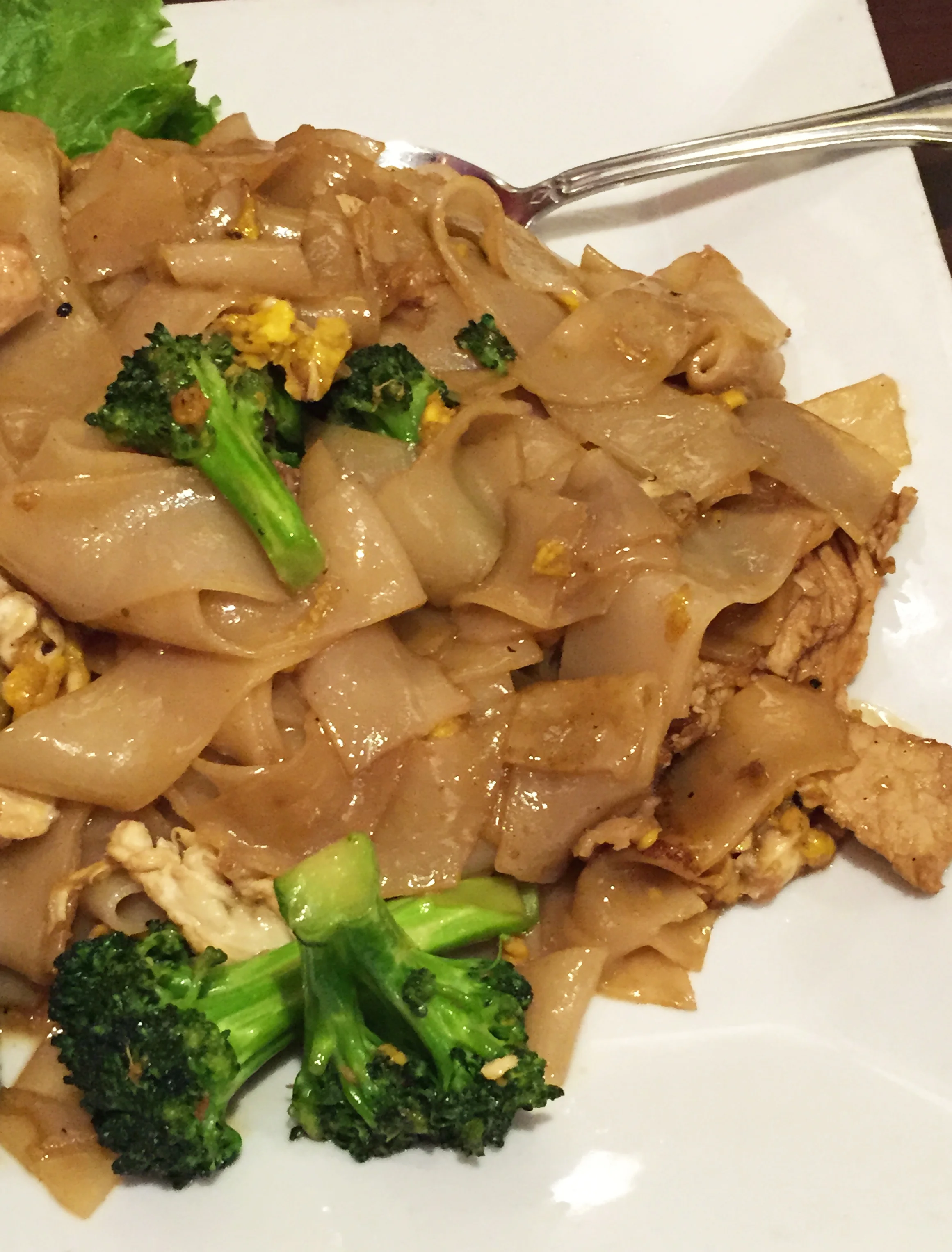 PAD SEE EW - Fresh rice noodle pan-fried with sweet soy sauce, chinese broccoli, egg, and chicken.