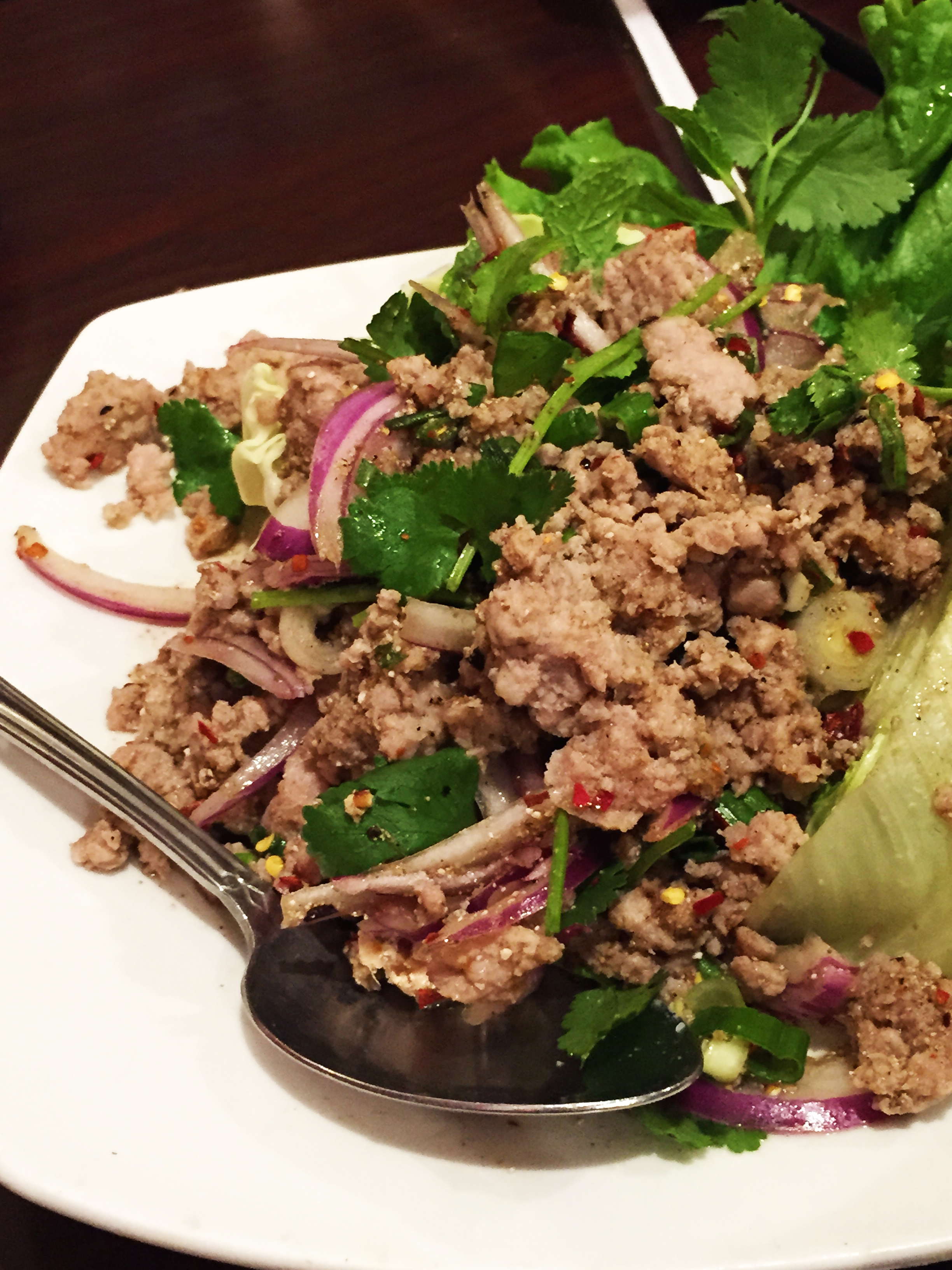 LARB - Quick boiled ground chicken seasoned with mint, chilies, lime juice, onions and ground roasted sweet rice.
