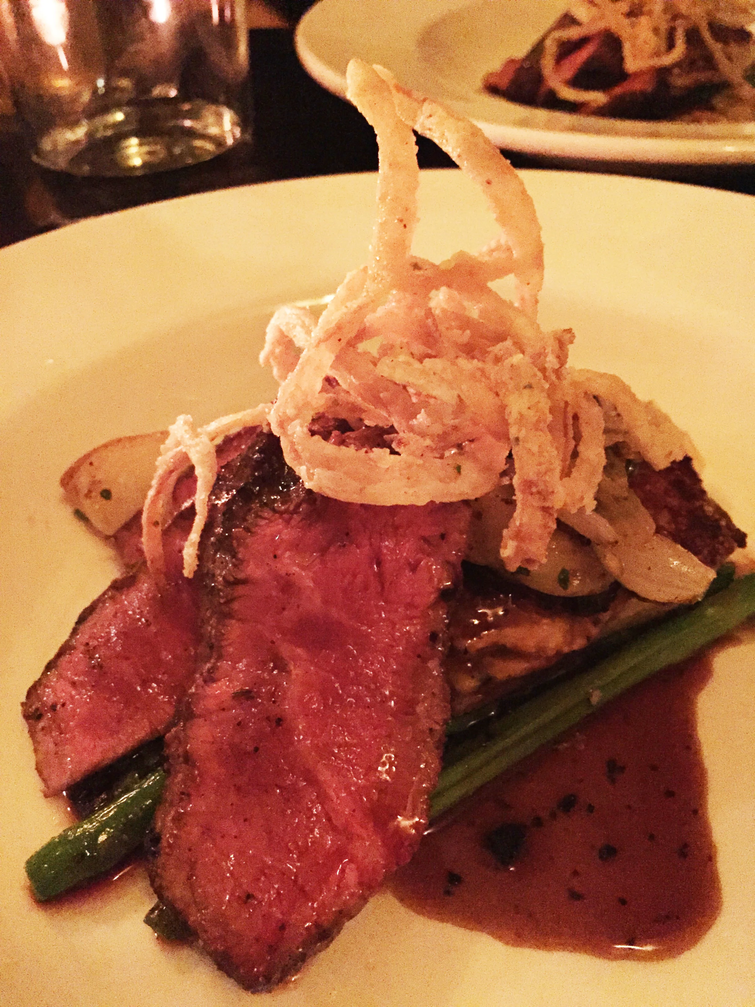 Charred Flat Iron with yukon potato gratin, black truffle mornay, asparagus, and truffle demi glace.