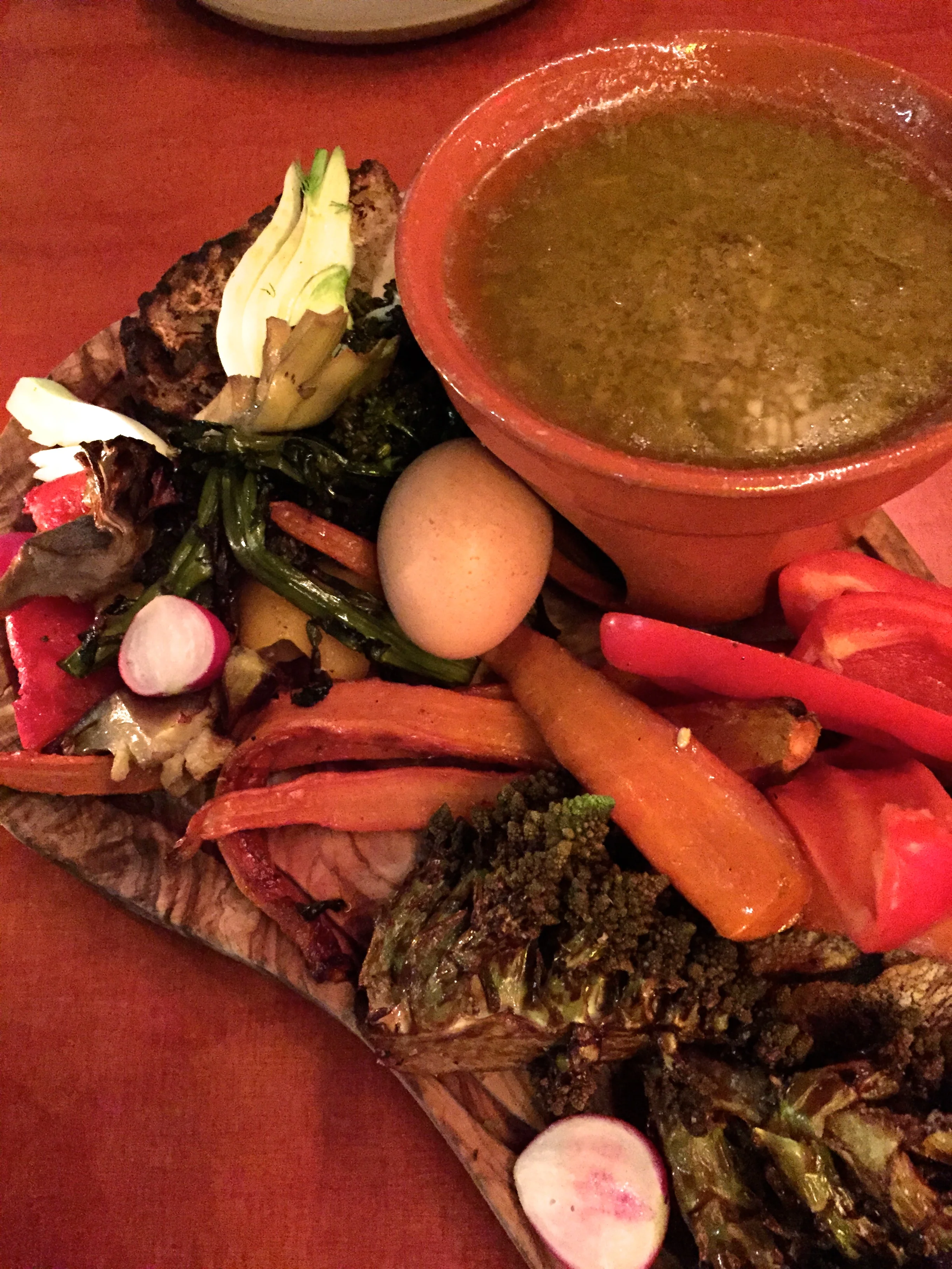 Bagna Caoda DOP with bread, vegetables, and a soft-boiled egg.