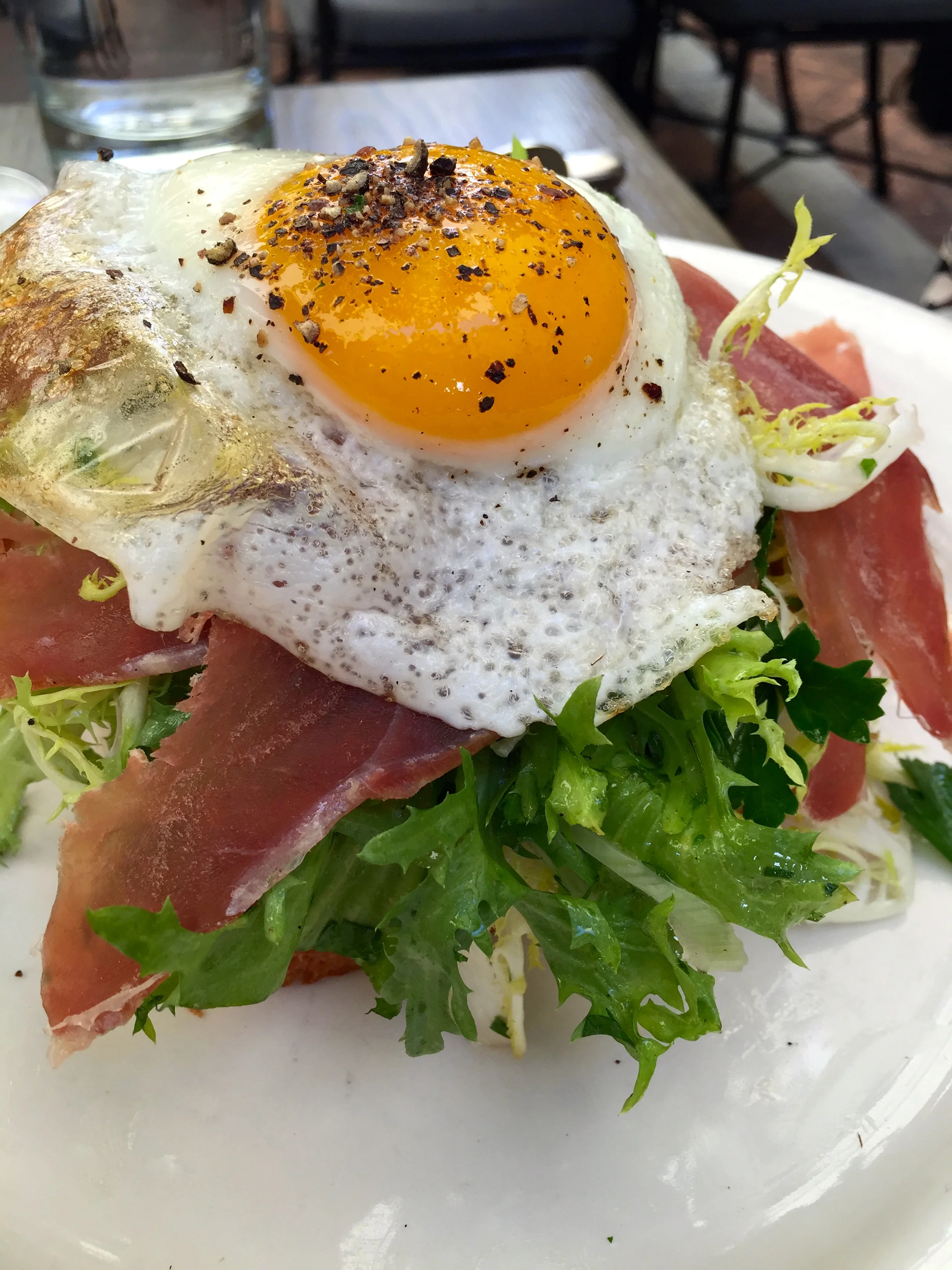 A.O.C. brioche with melted gruyère, frisée, prosciutto & sunny-side up egg.