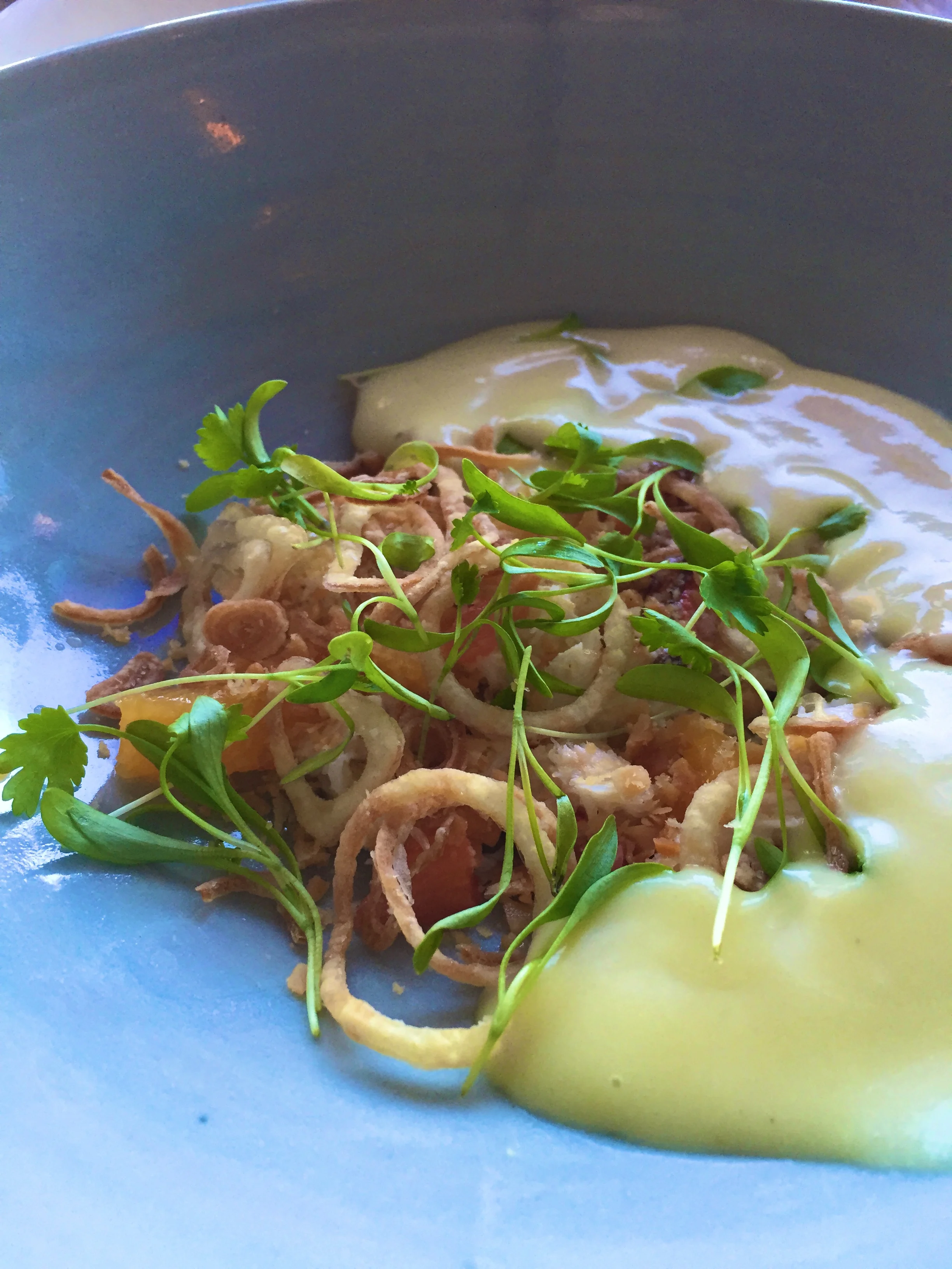 Dungeness crab & curry mojo citrus, white yam, crispy shallot, macadamia, and cilantro.