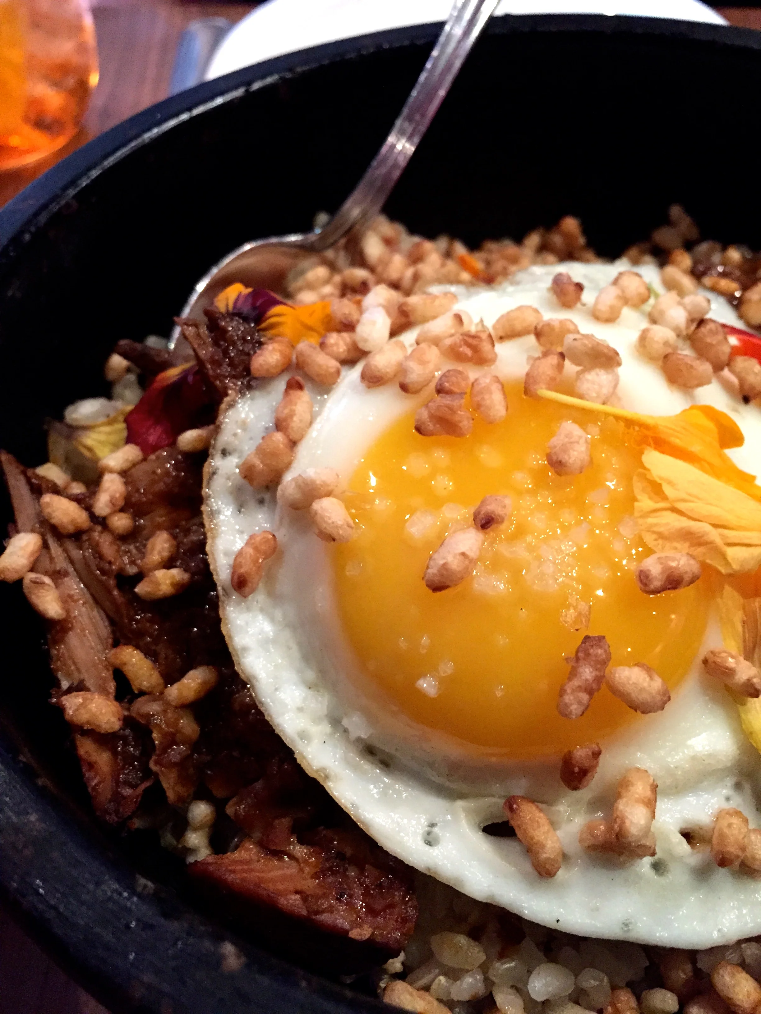 Romesco Braised Pork Belly with crispy satsuki rice, charred leek, and a fried egg.
