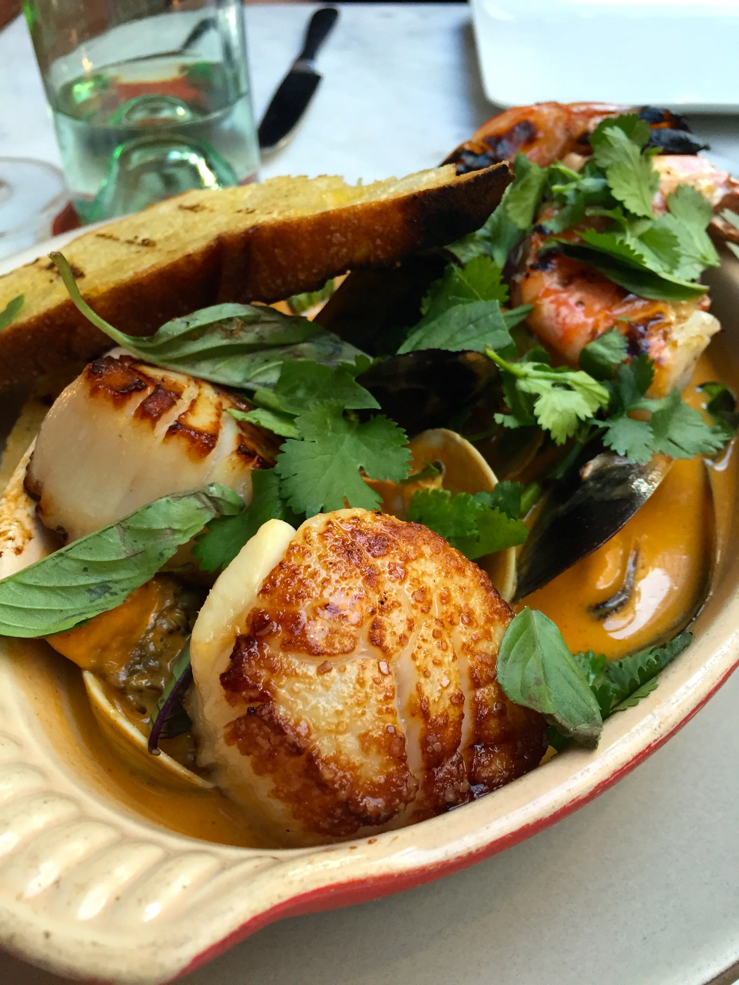 Shellfish pot with scallops, clams, mussels, shrimp, maitake mushrooms and curry.