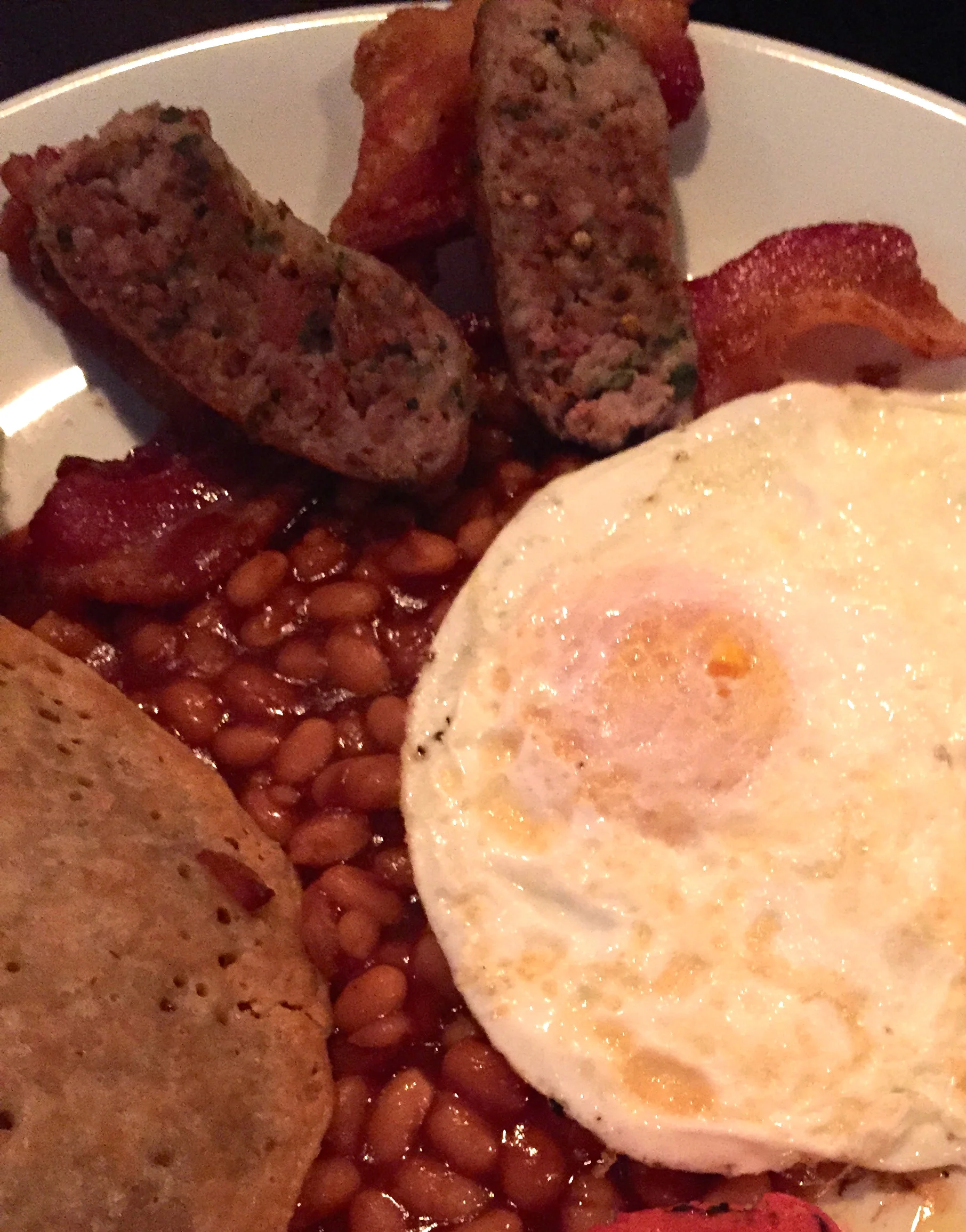 Full English Breakfast, two organic pastured eggs any style, served with two house made bangers, two rashers of streaky bacon, beans, toast and an oatcake.