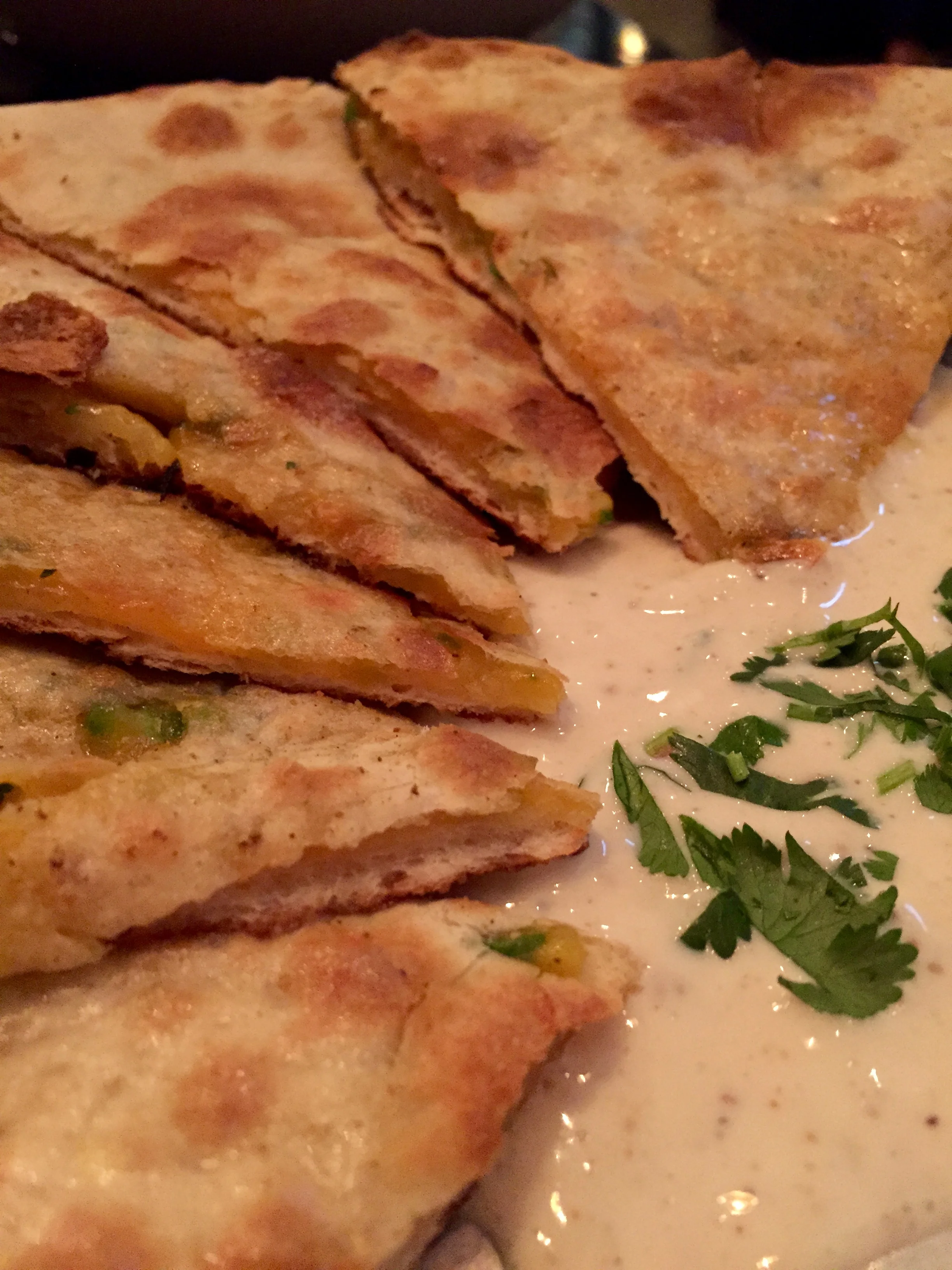 Chili Cheese Naan stuffed with American cheddar, serrano chillies and cilantro, cooked in the tandoor.