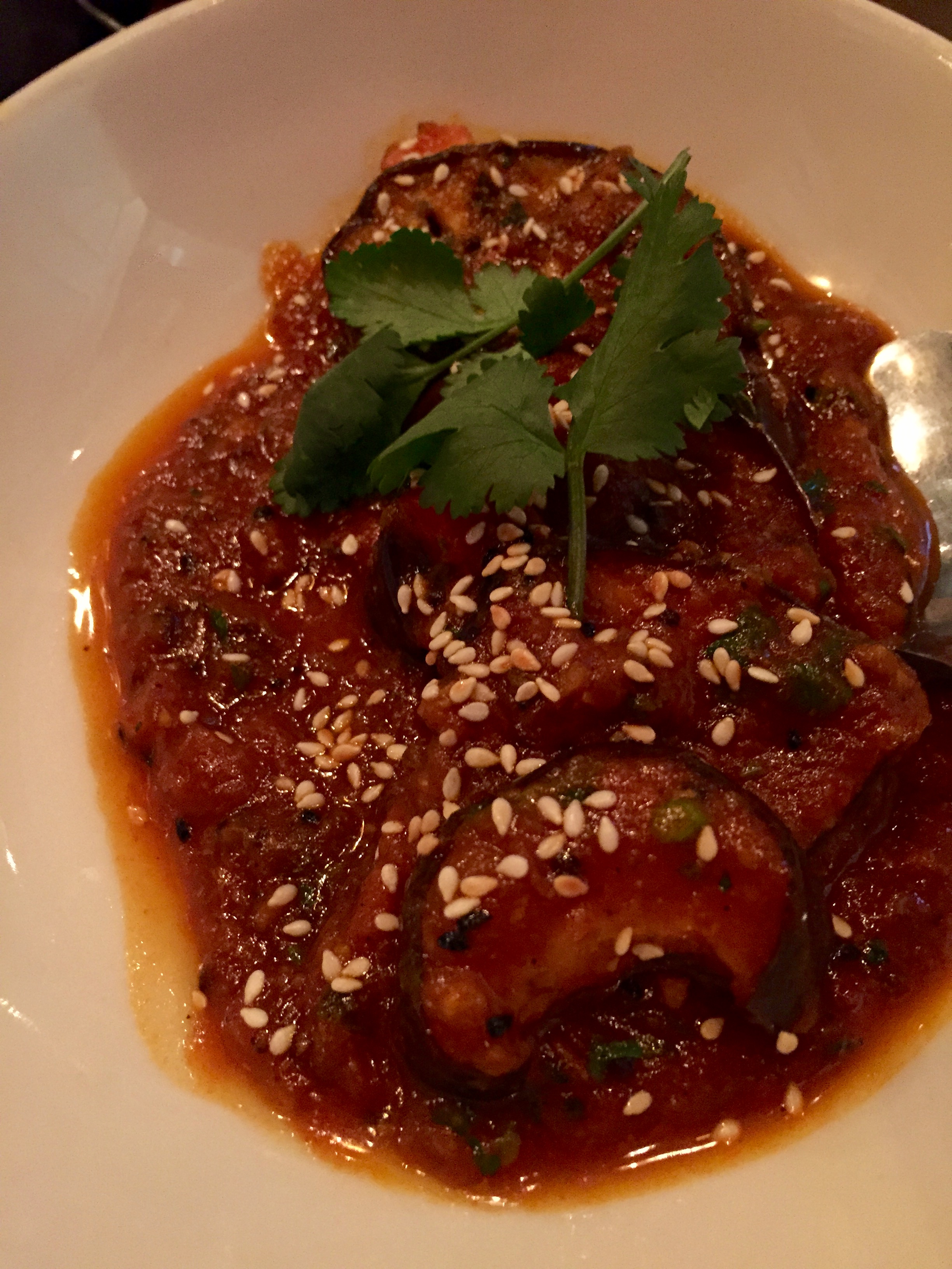 Eggplant Dish No. 3 - eggplant steaks with a tangy tomato & mustard seed sauce, finished with toasted sesame seeds.