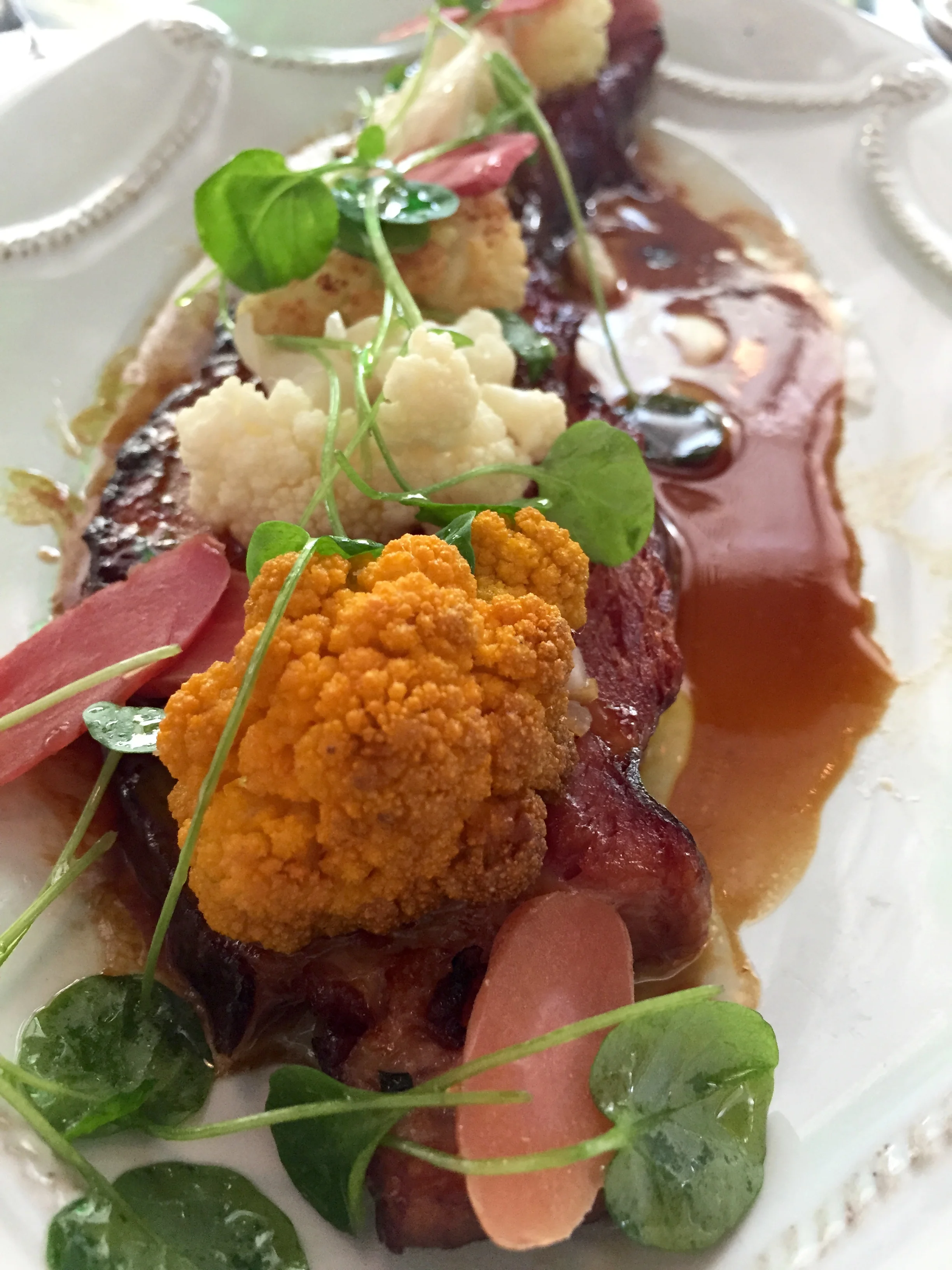 Braised Bacon with roasted cauliflower, salsa verde, and Champagne glaze.