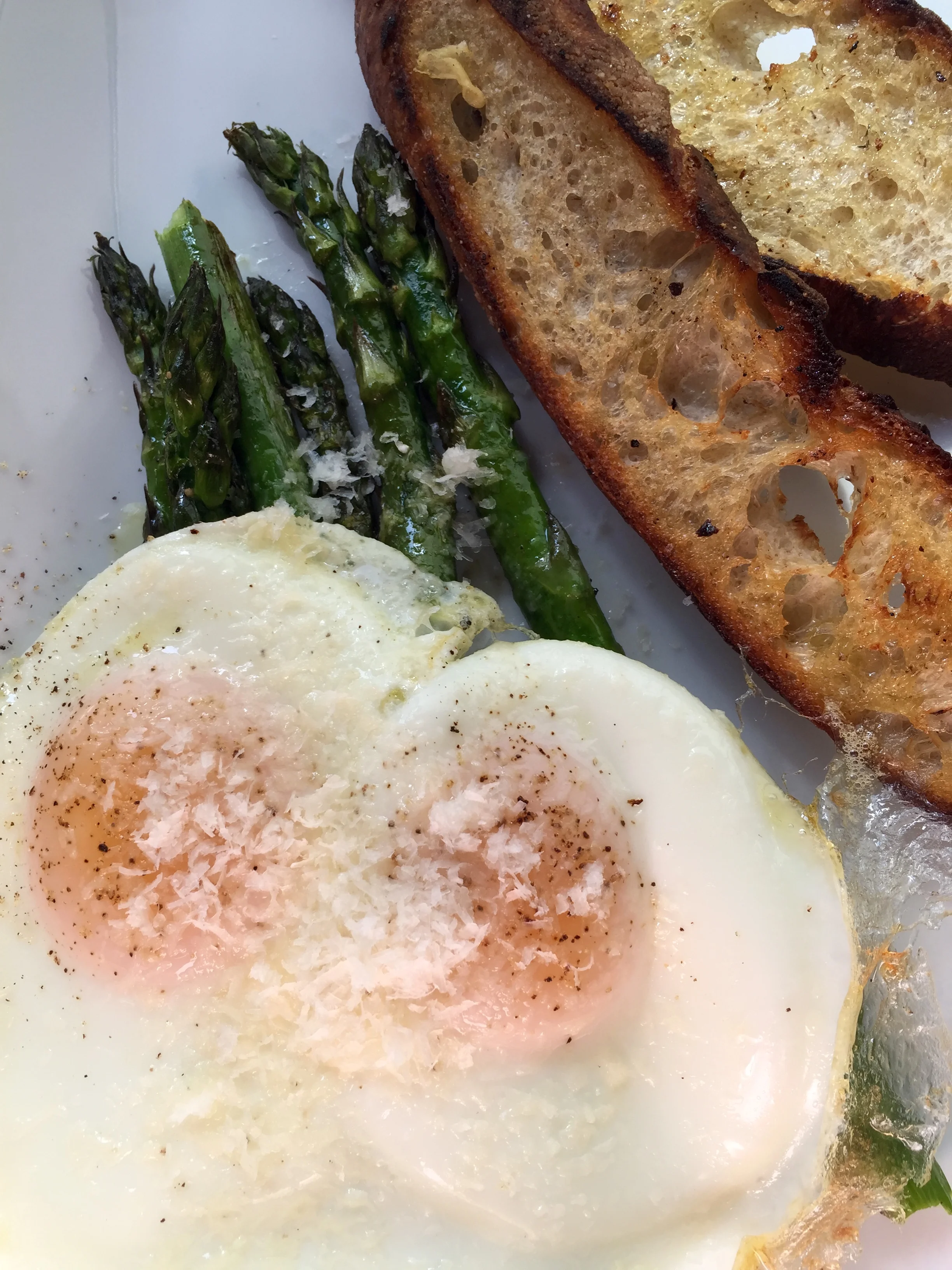 WOOD-FIRED ASPARAGUS - sunny-side up eggs, parmesan, toasted baguette, and lemon.