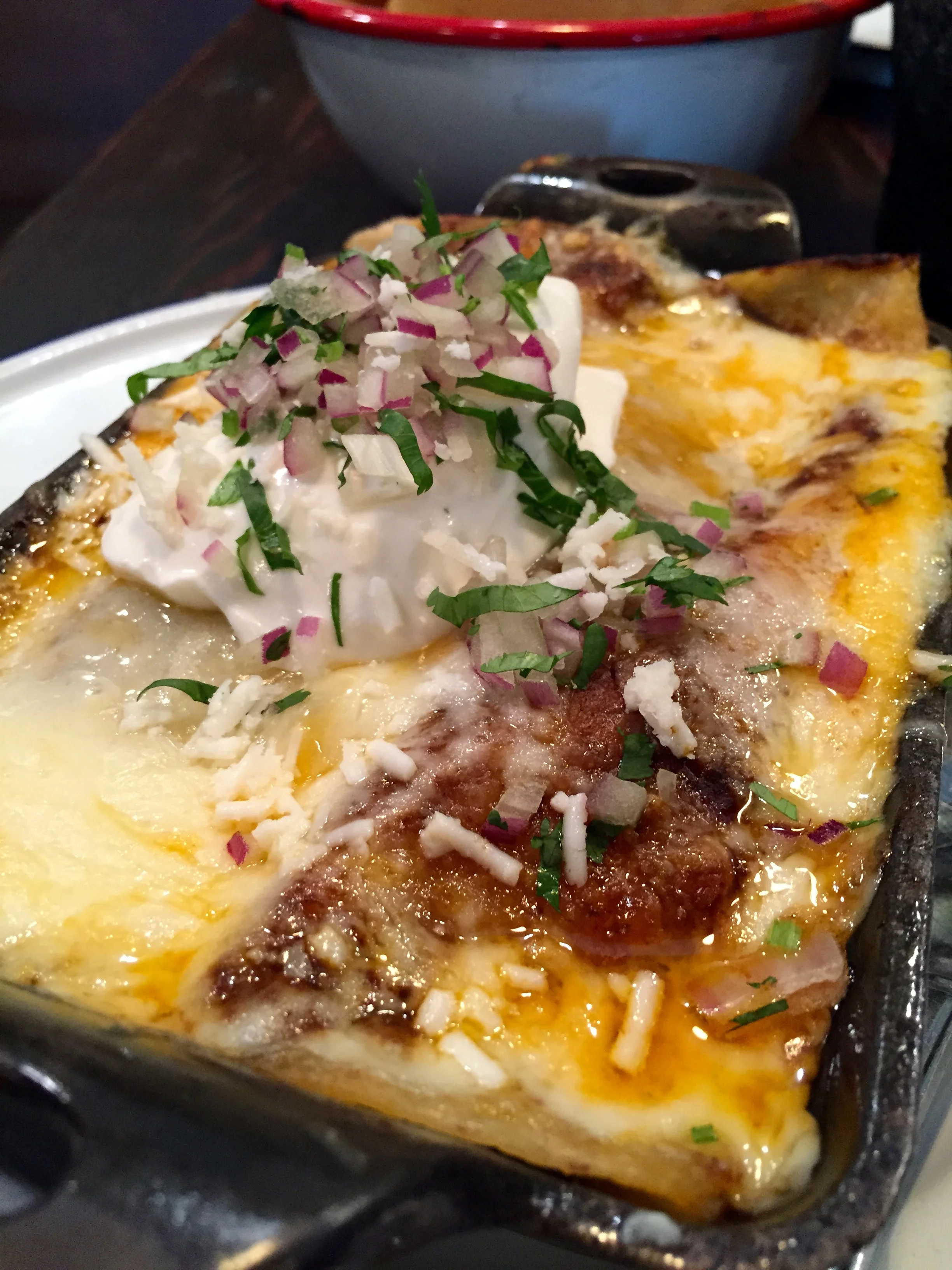 Mole Lengua Enchiladas with monterey jack, cheddar, and onion.