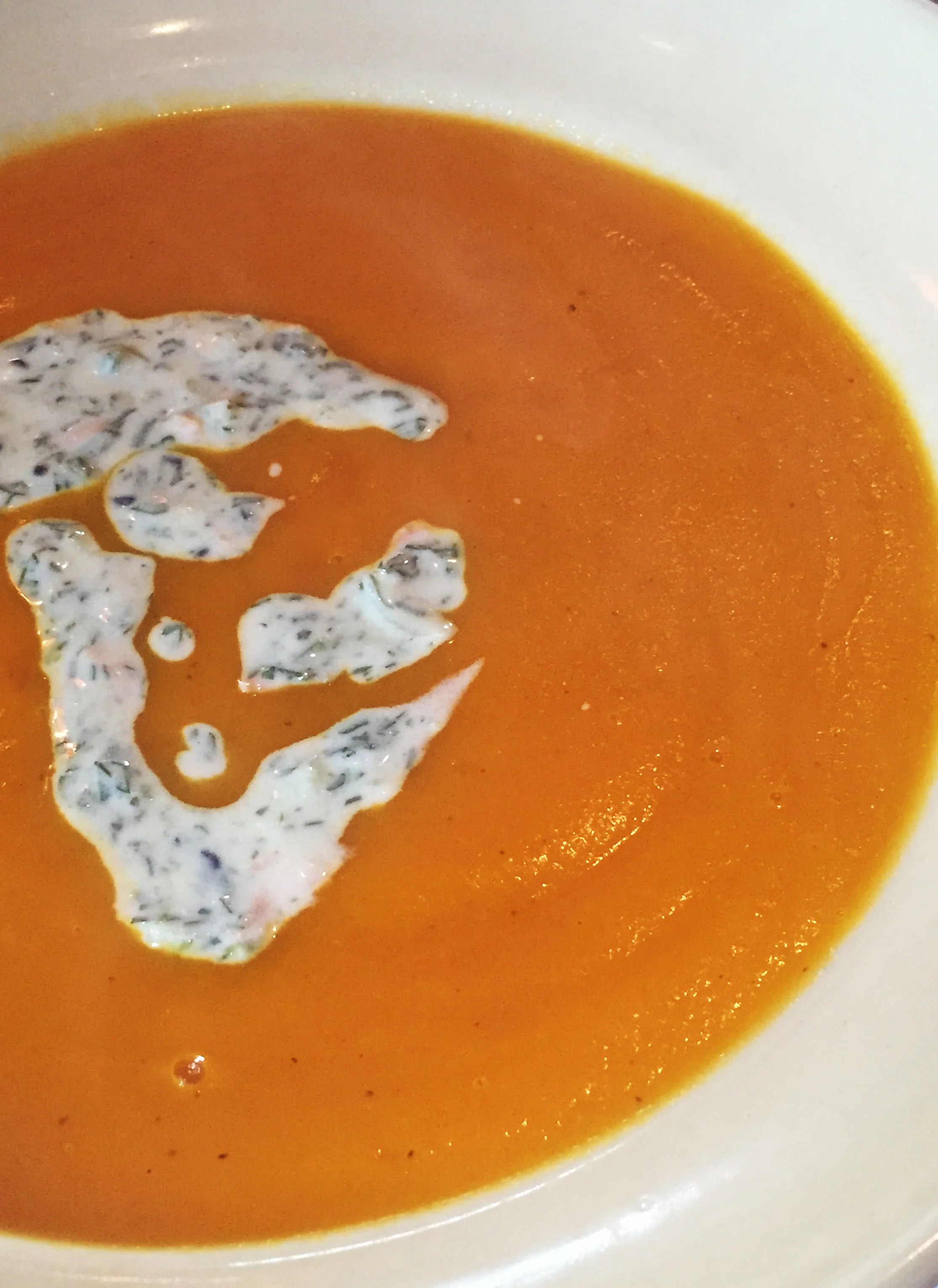 Carrot soup with green coriander and mint raita.