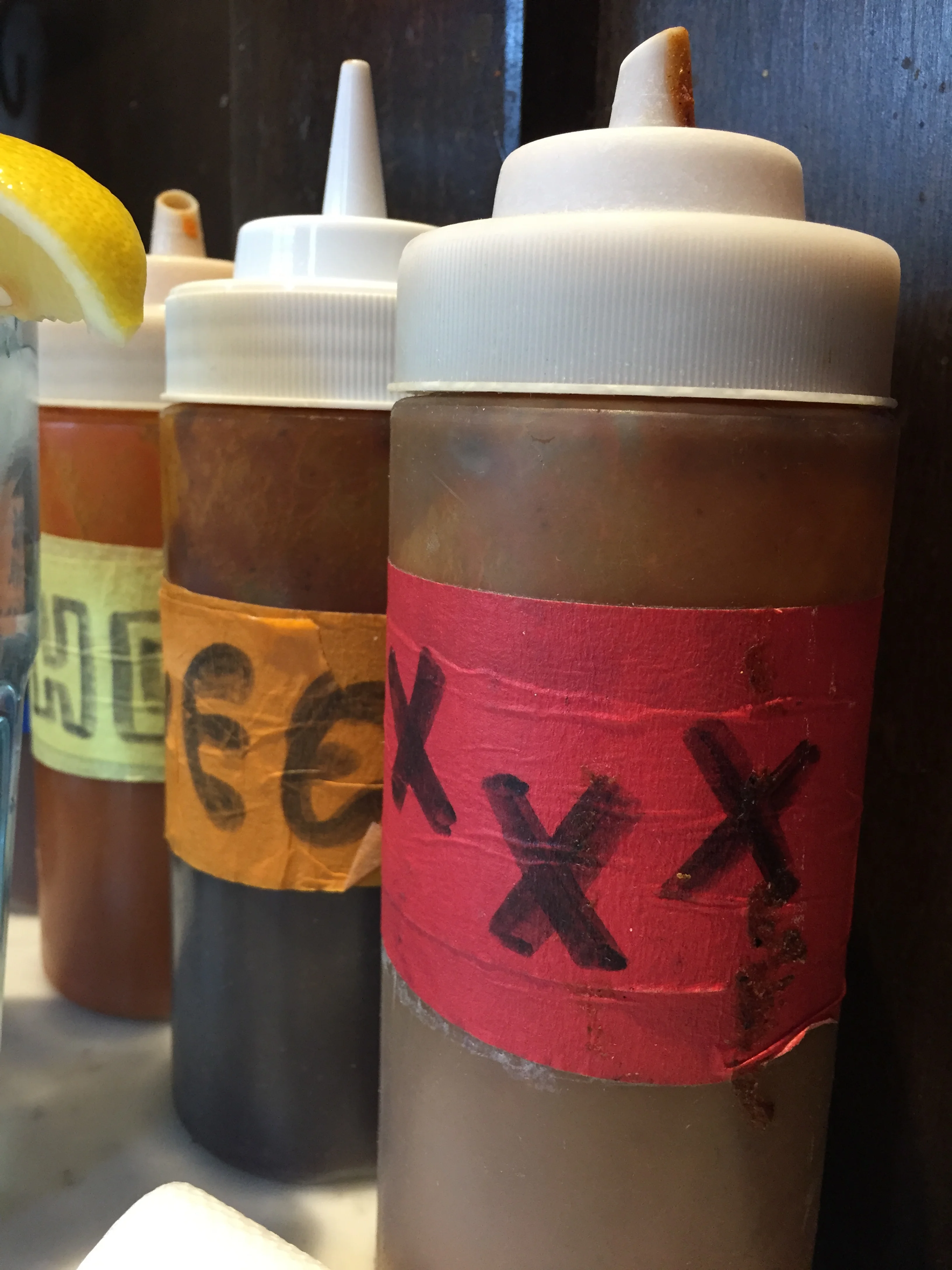 XXX Sauce with habanero, serrano, poblano, pineapple, raspberry and mango. Sweet Sauce with tangy BBQ-molasses flavor. Hot Sauce with "Buffalo"-style medium favor and a hint of ginger.