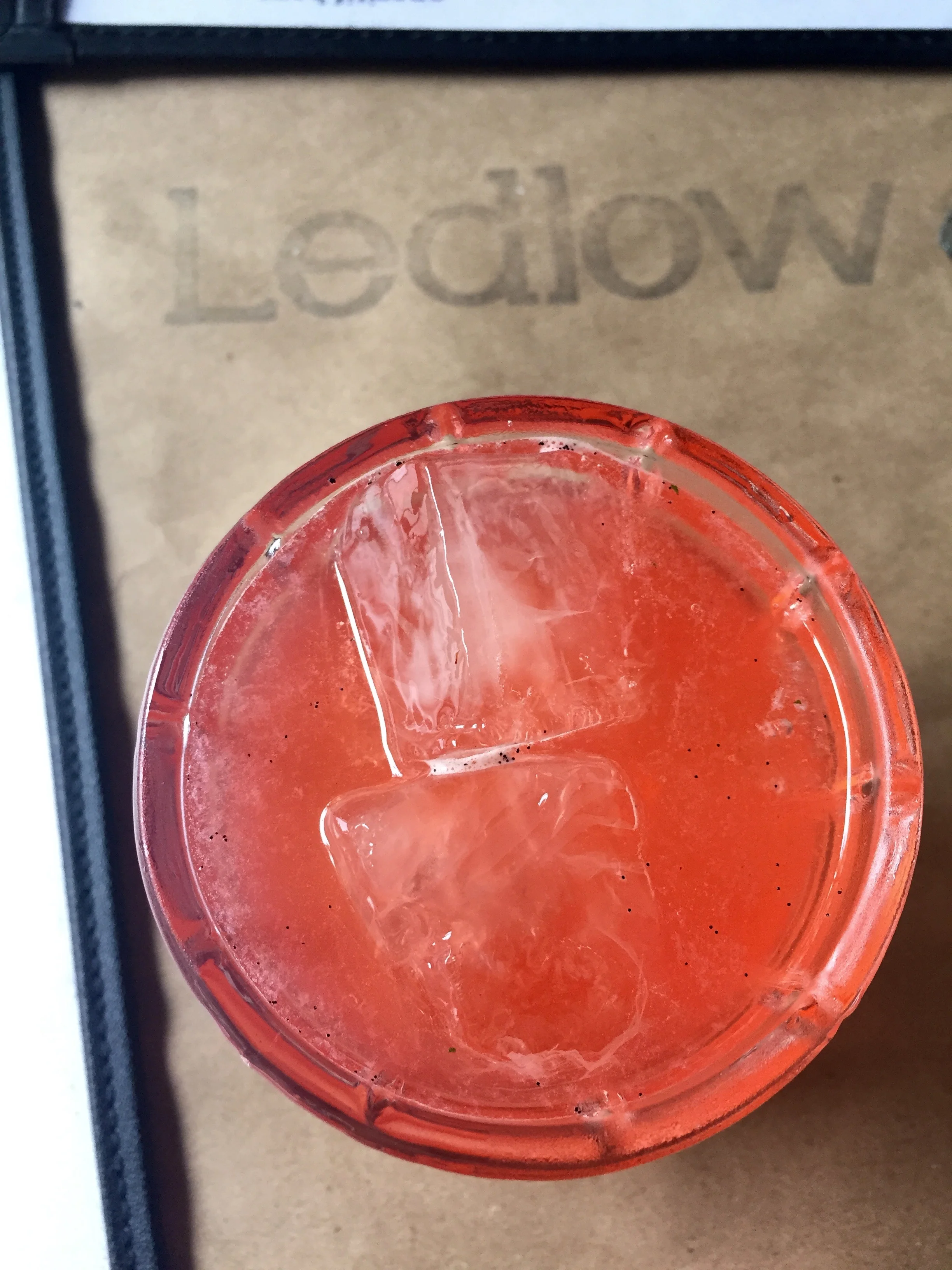 Summer Babe cocktail with tequila, Campari, lemon, vanilla, mint, and smoked strawberry.