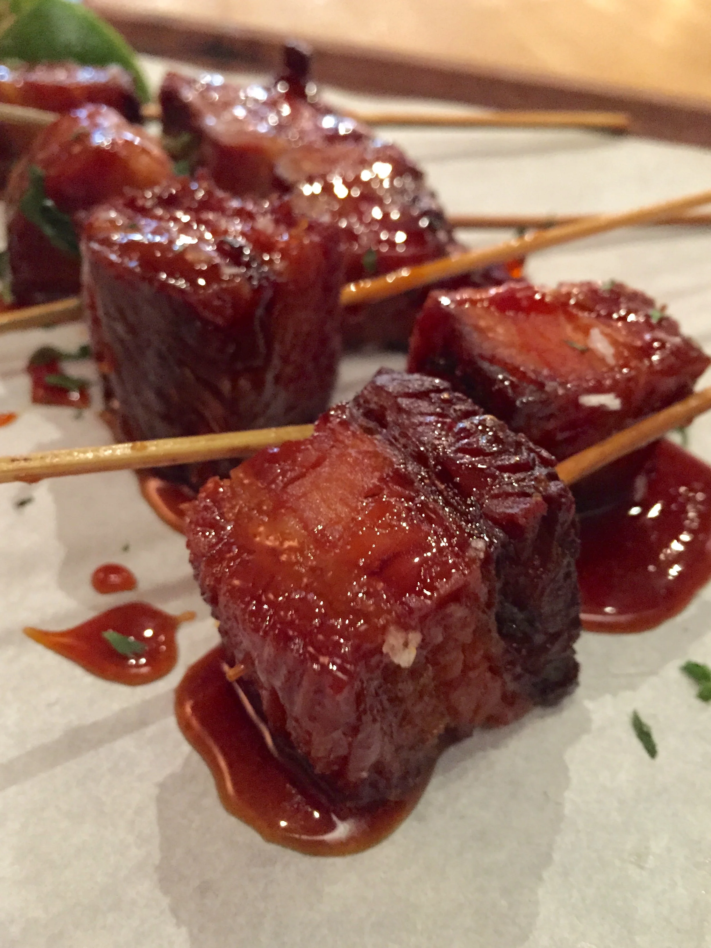 Pork Belly Skewers with maple glaze, lime, and cilantro.