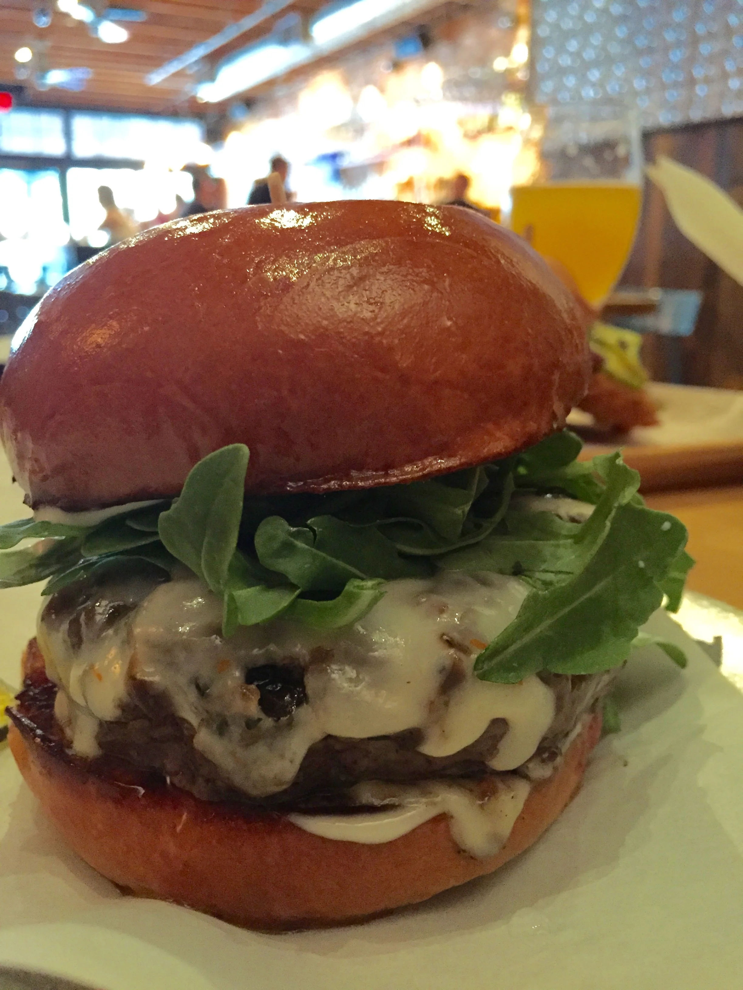 Bistro Burger with arugula, worcestershire onions, port salut, and aioli.