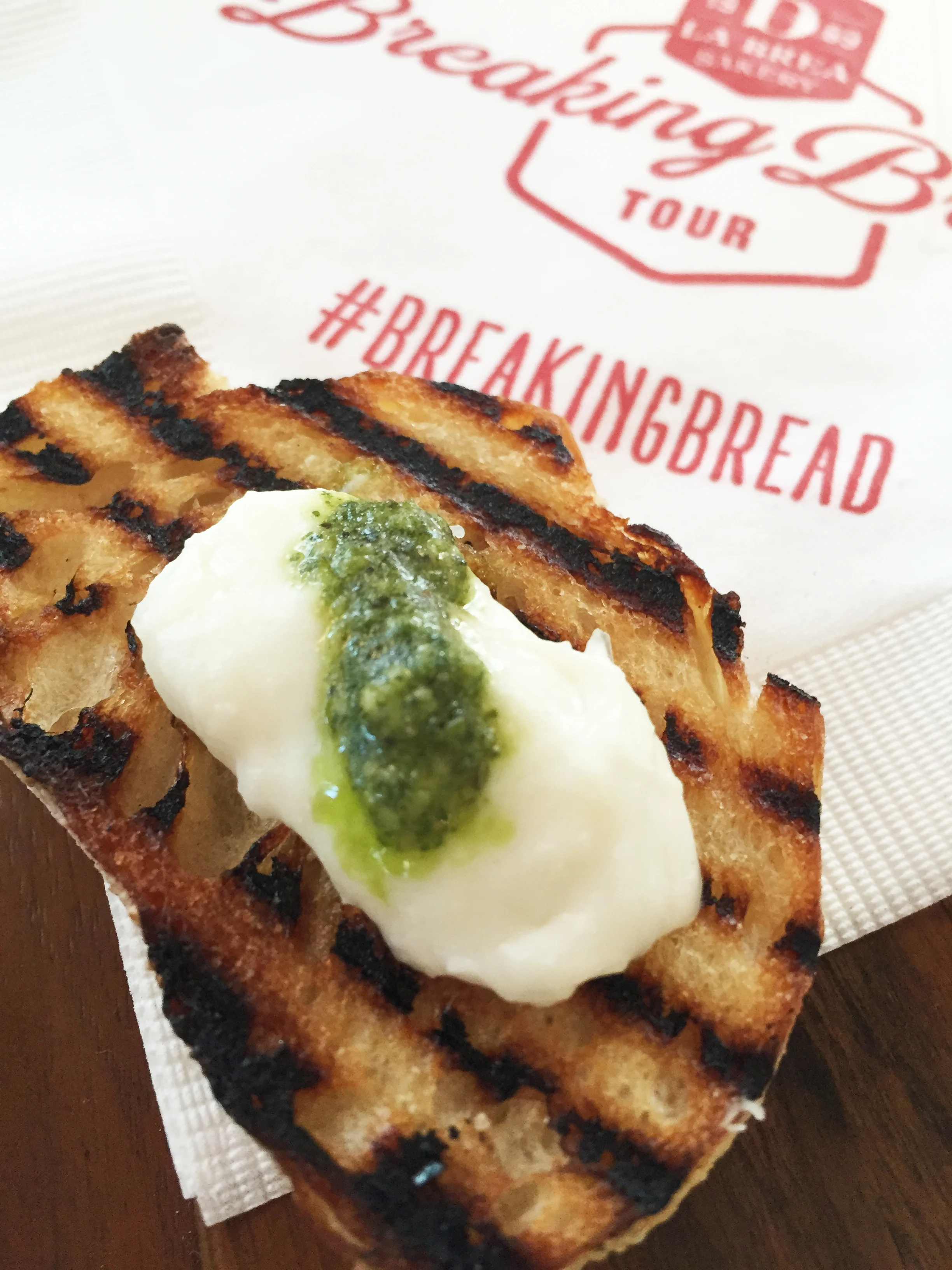 Grilled baguette with burrata and pesto.