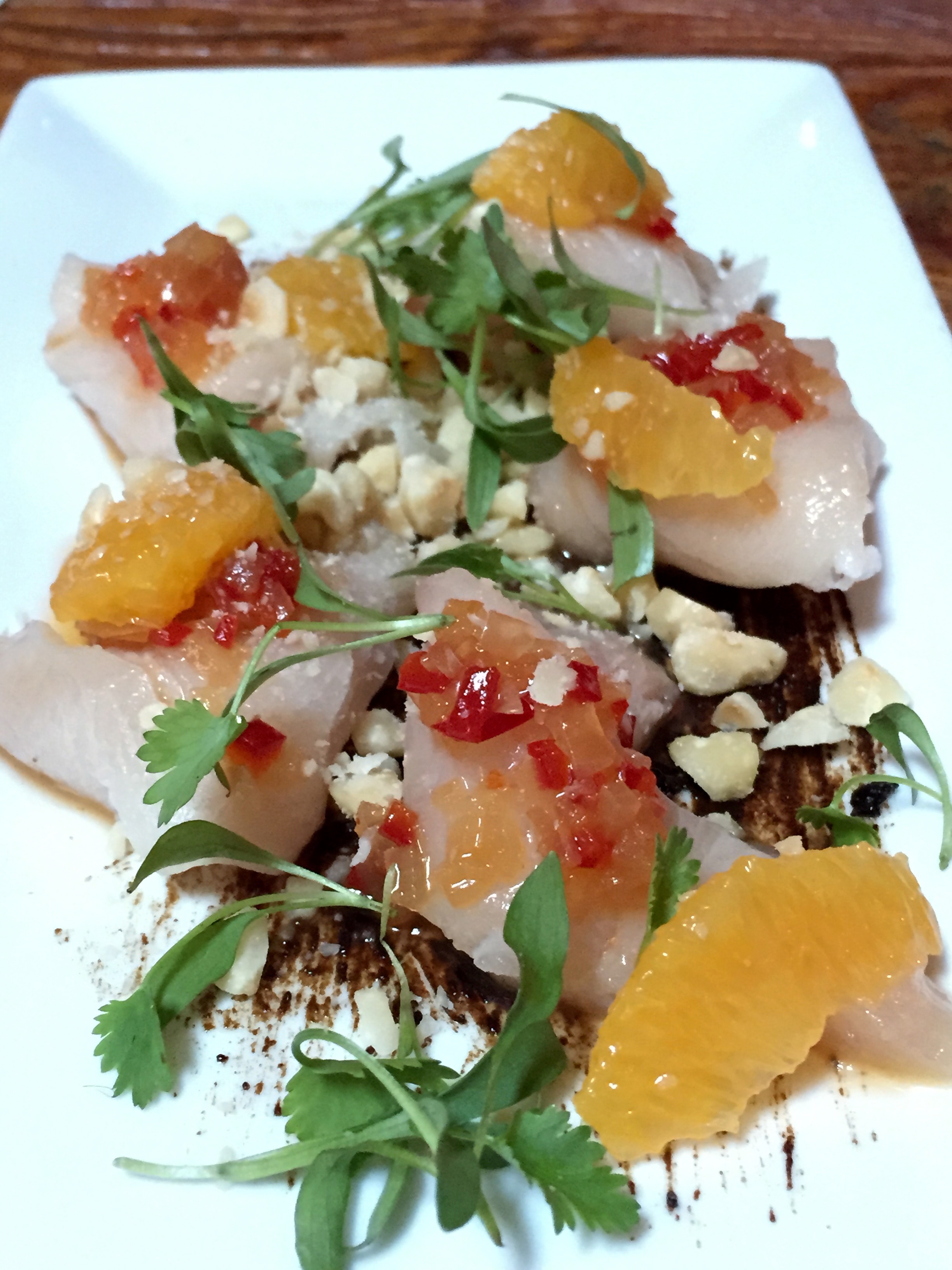 Hamachi with blood orange, black garlic, hazelnuts, cilantro and ginger vinaigrette.