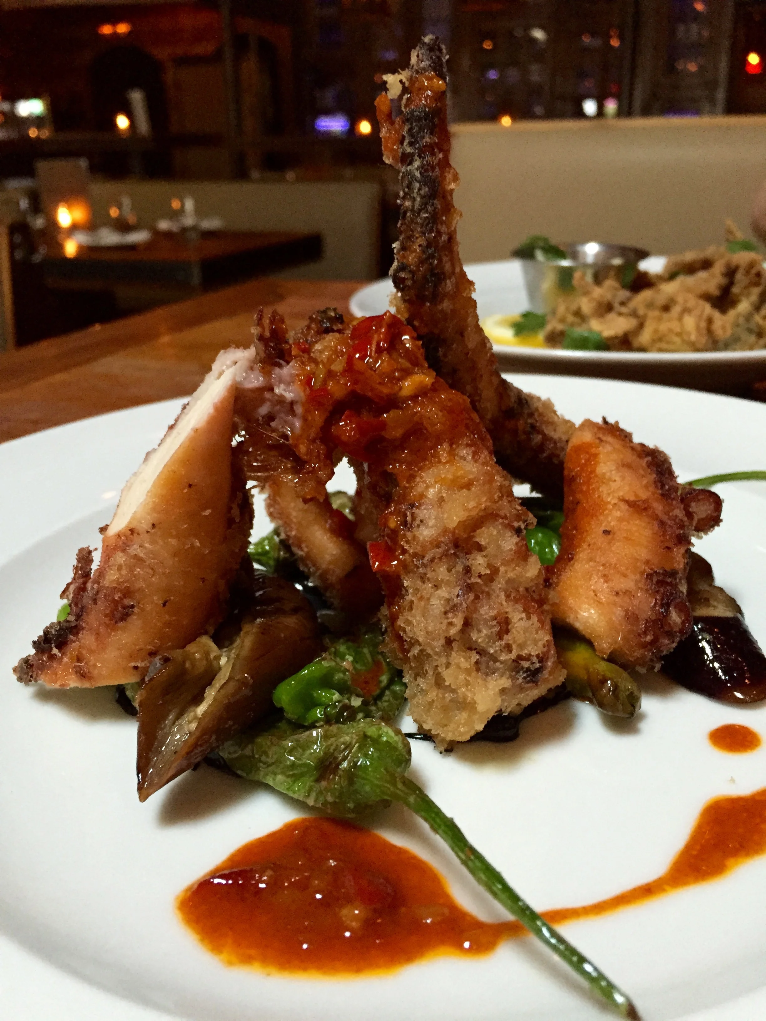 Fried Octopus with squid ink aioli, eggplant, shishito peppers, and mojo.