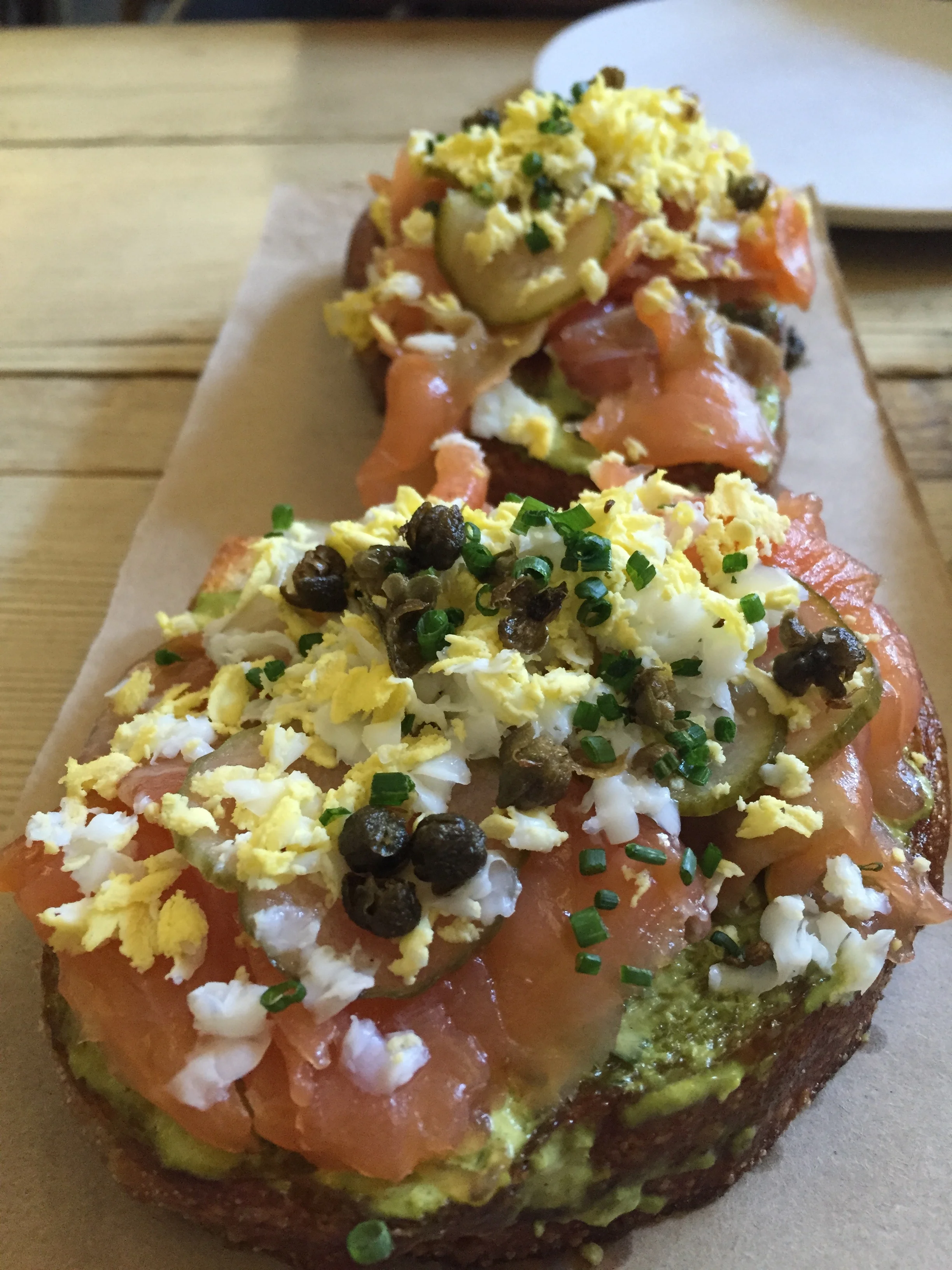 Citrus-cured Salmon Tartine with sauce gribiche, egg, capers, and dill pickles.