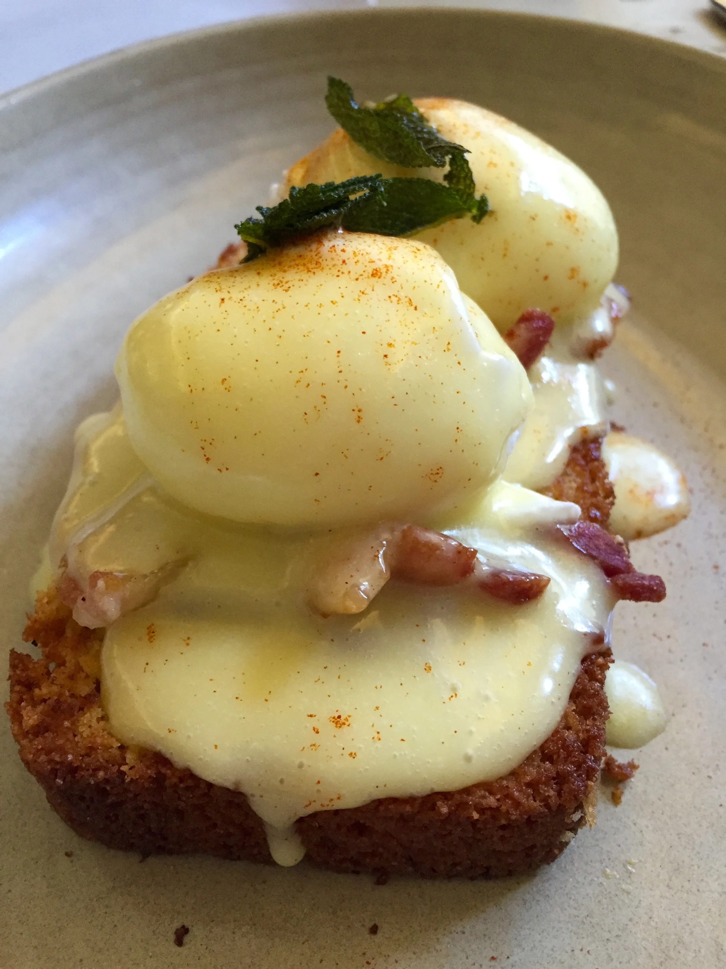 Smoked Pork Belly Benedict on corn bread with poached eggs and pimento hollandaise.