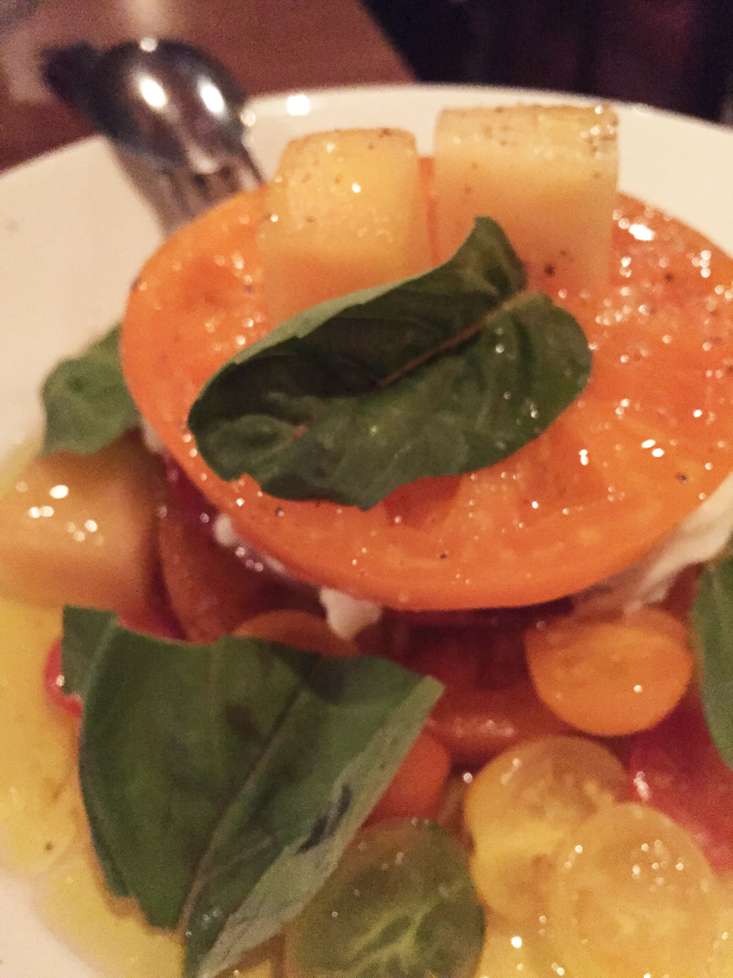 Munak Ranch Heirloom Tomatoes with Gioia burrata, summer melons, and basil.