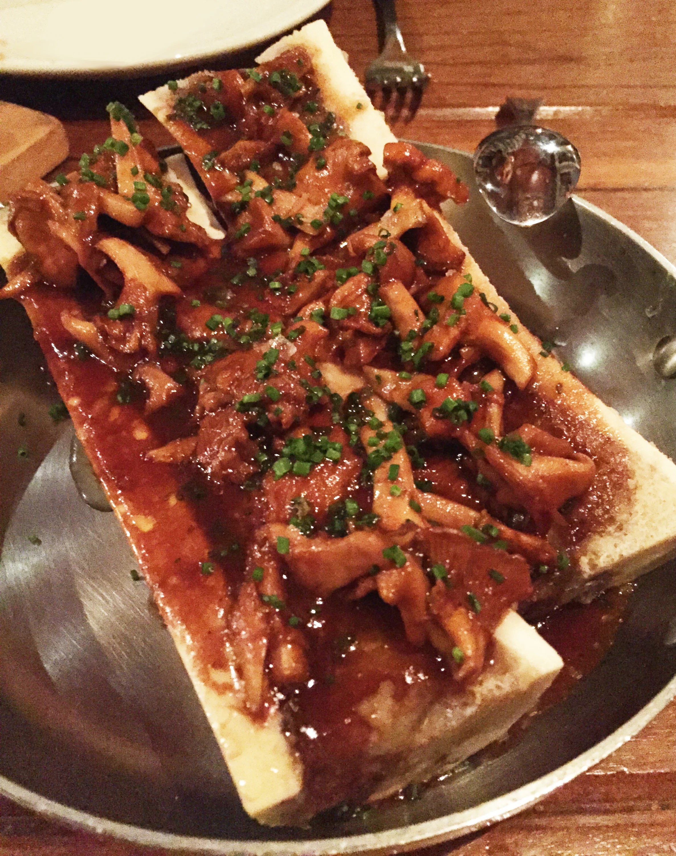 Roasted Bone Marrow with chanterelle mushrooms and garlic bread.