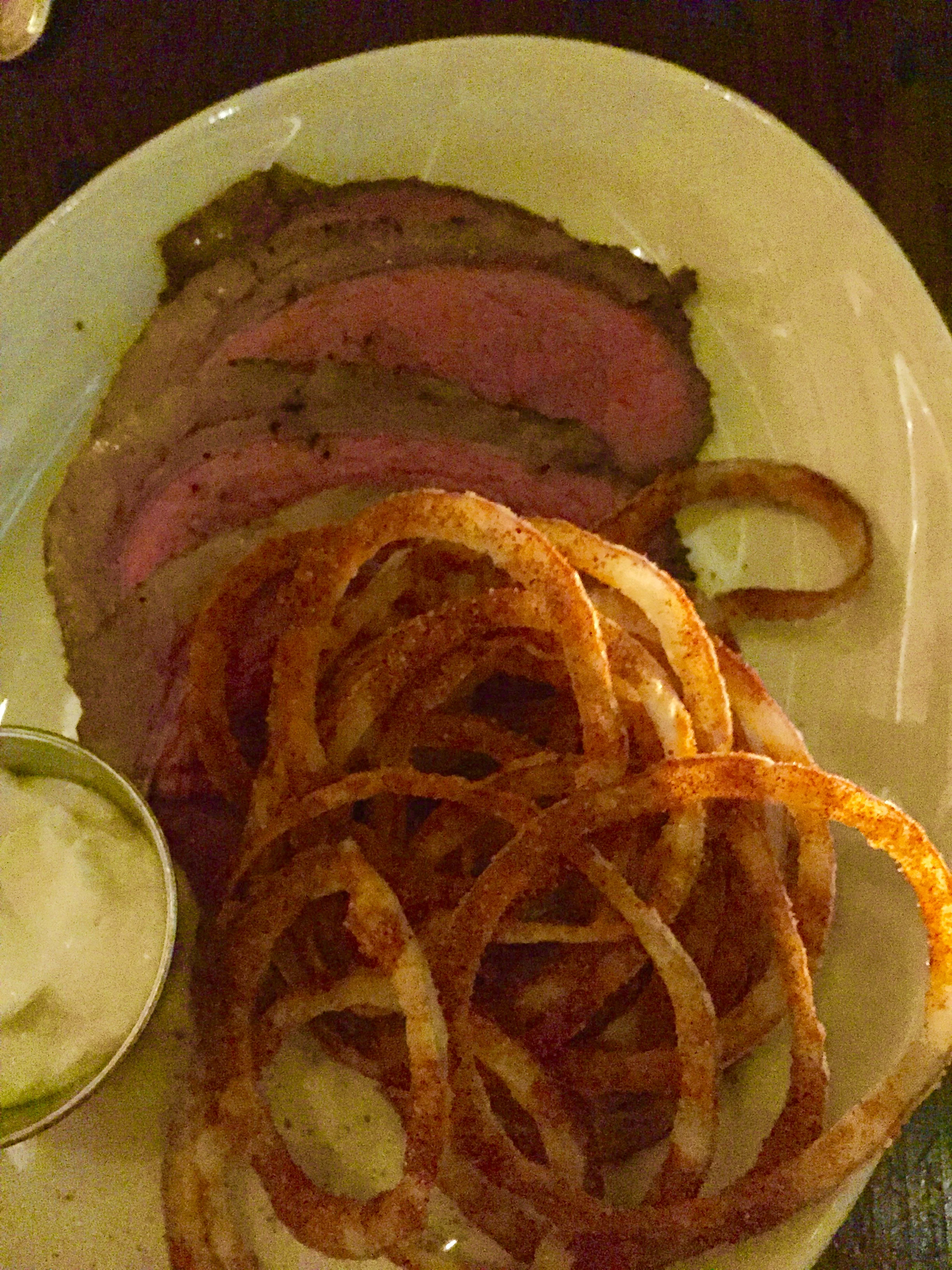 Dry-aged Sirloin cap with crispy onions and horseradish cream.