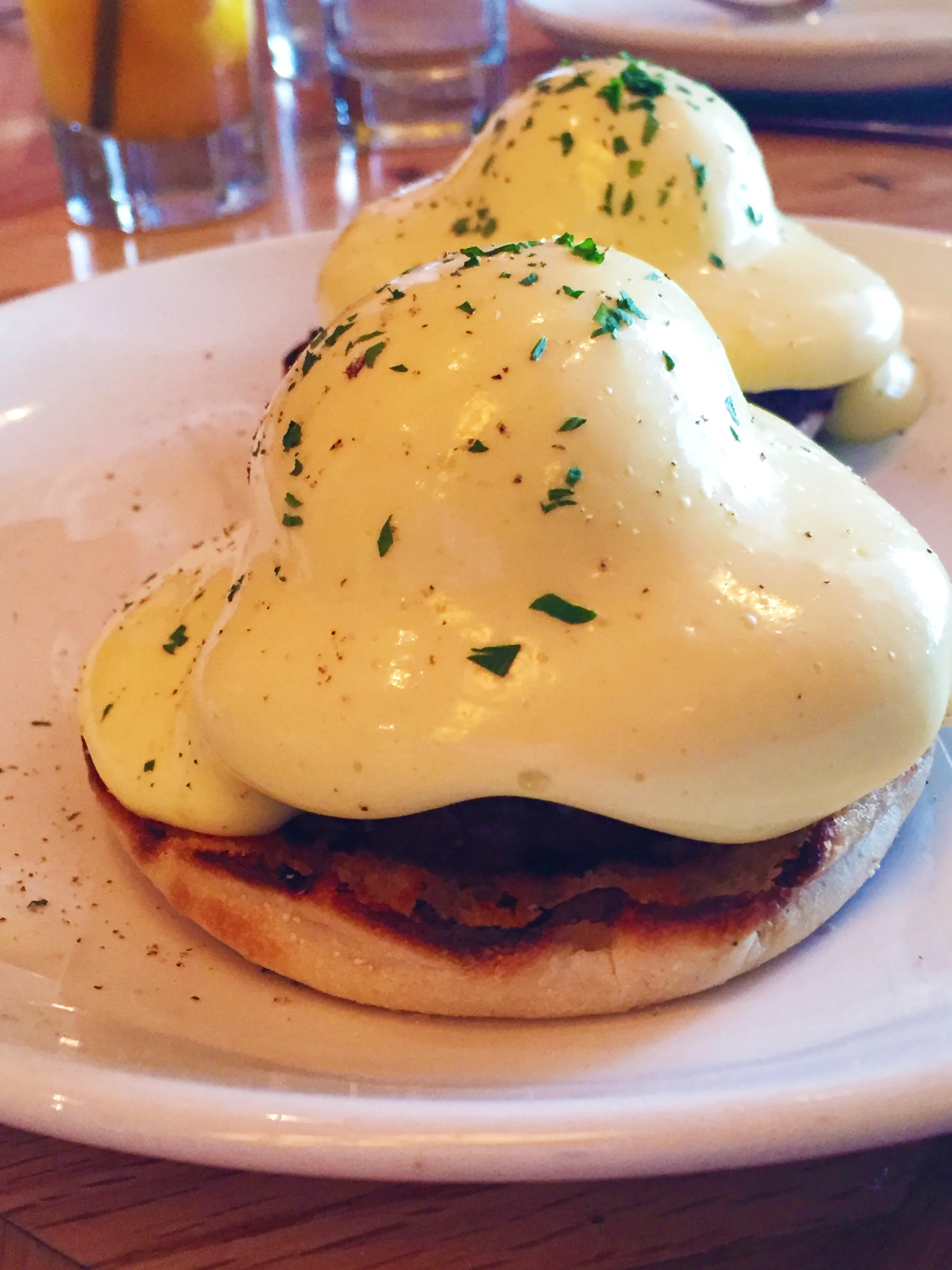 Smoked Pork Benedict with smoked pork roast, tomato, hollandaise, and english muffin.
