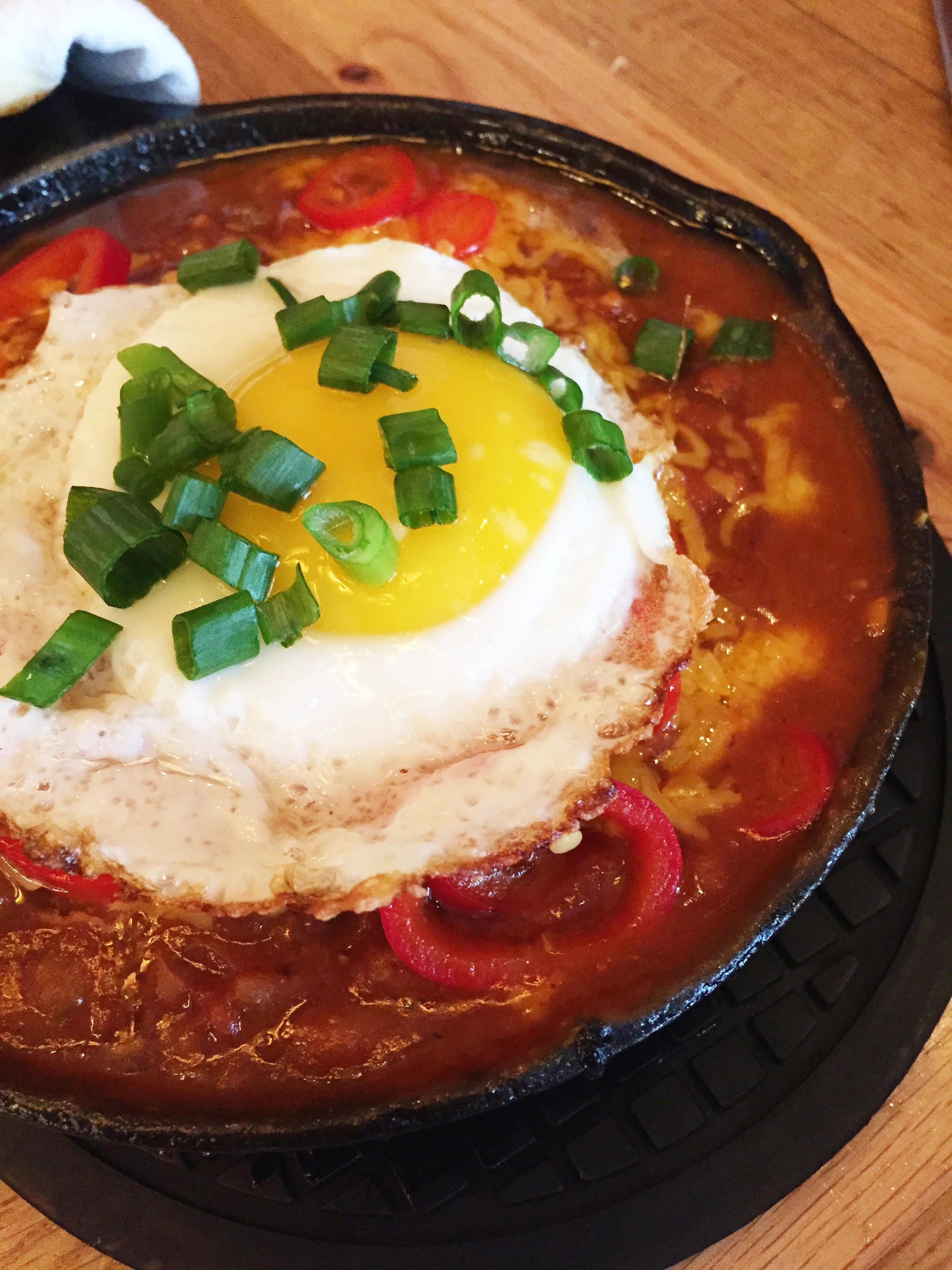 Hangover Hoe Cake with fried egg, chili, cheddar, green onions, and pickled chilies.