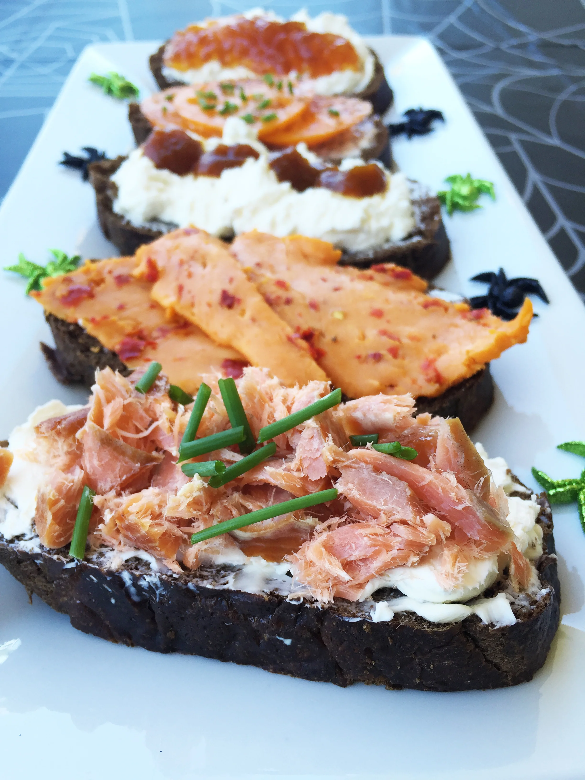 top to bottom : Ricotta and orange marmalade; Orange heirloom tomato slices with sweet butter and chives; Ricotta and pumpkin butter; Cheddar cheese with red jalapeno peppers; Flakes of hot smoked salmon with crème fraîche and chives