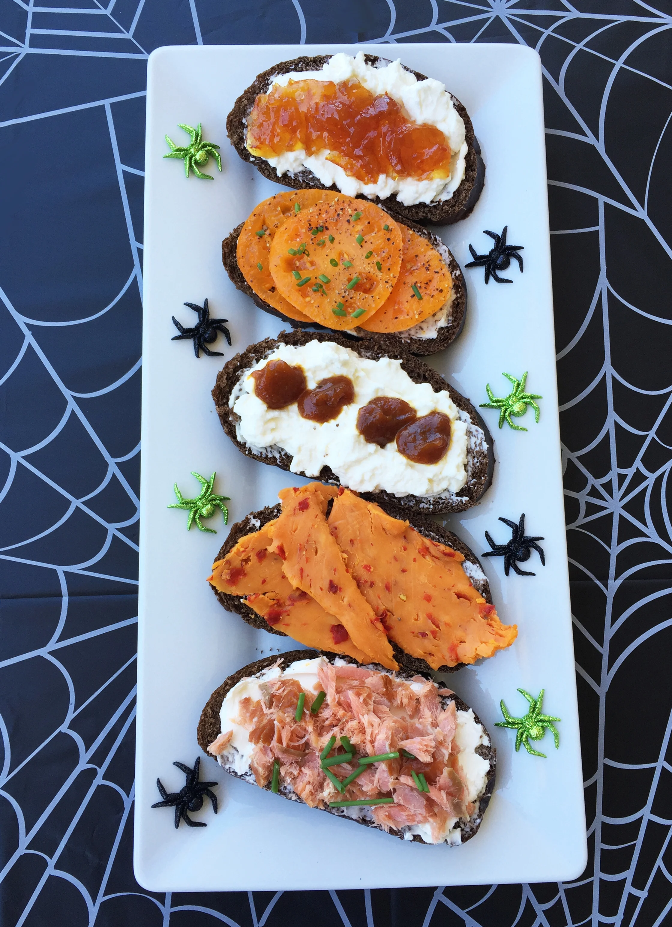 top to bottom : Ricotta and orange marmalade; Orange heirloom tomato slices with sweet butter and chives; Ricotta and pumpkin butter; Cheddar cheese with red jalapeno peppers; Flakes of hot smoked salmon with crème fraîche and chives