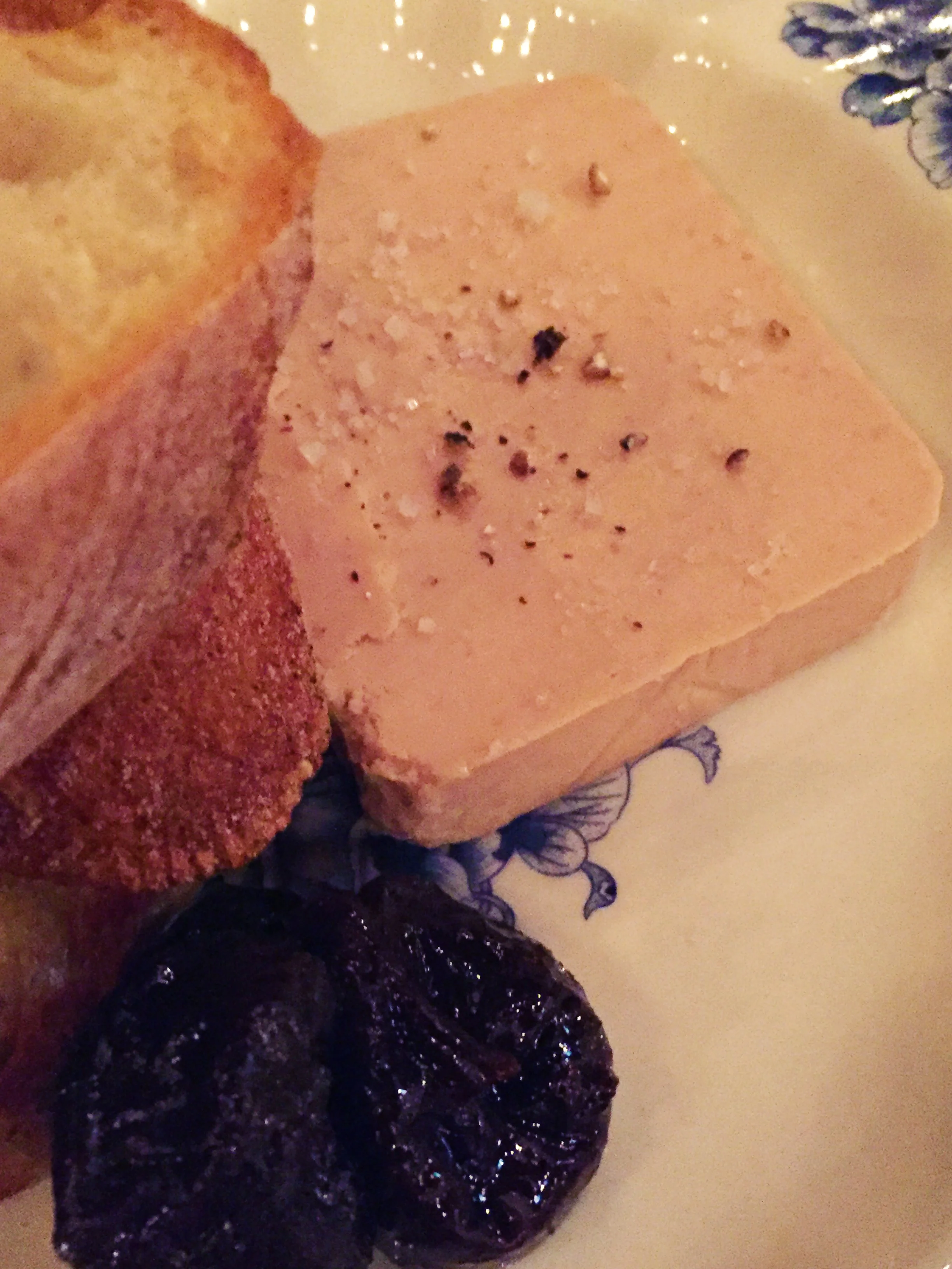 Terrine de Foie Gras with sweet & sour prunes, baguette, and black pepper.