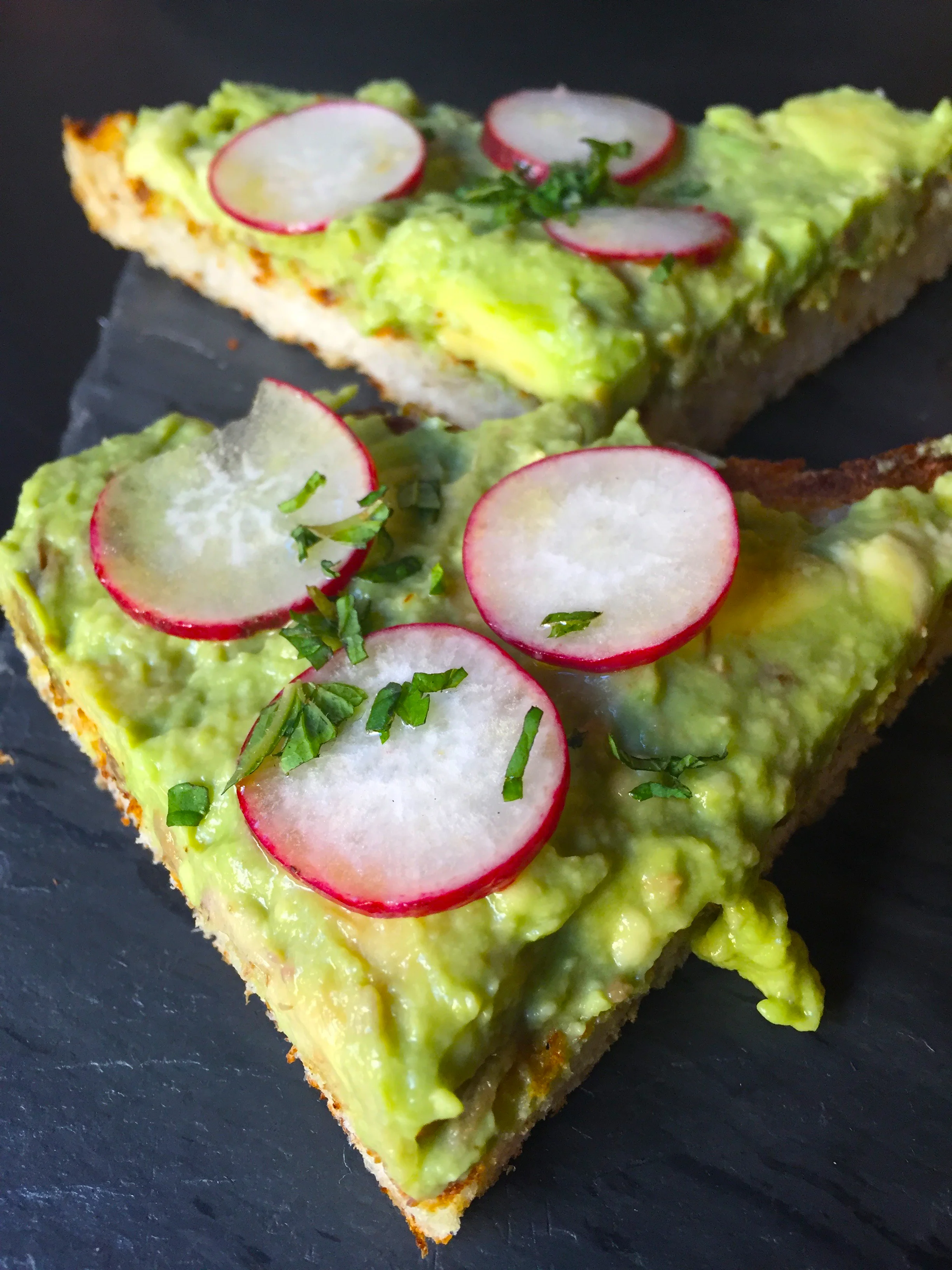 Smashed Avocado Toast with radish and fresh mint.