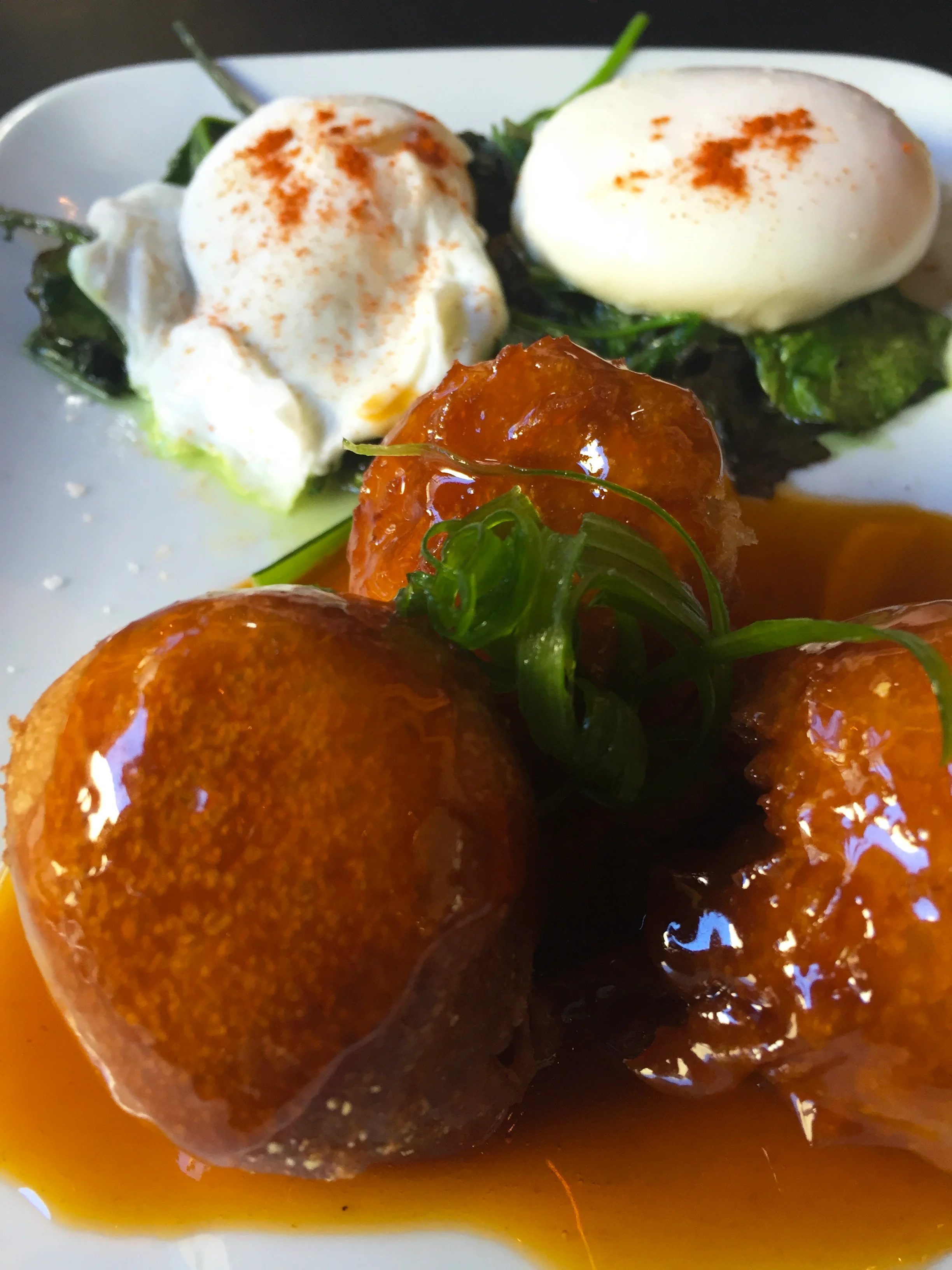 Chicken and Waffle Croquettes with bacon, spicy maple sauce, braised greens and slow cooked eggs.