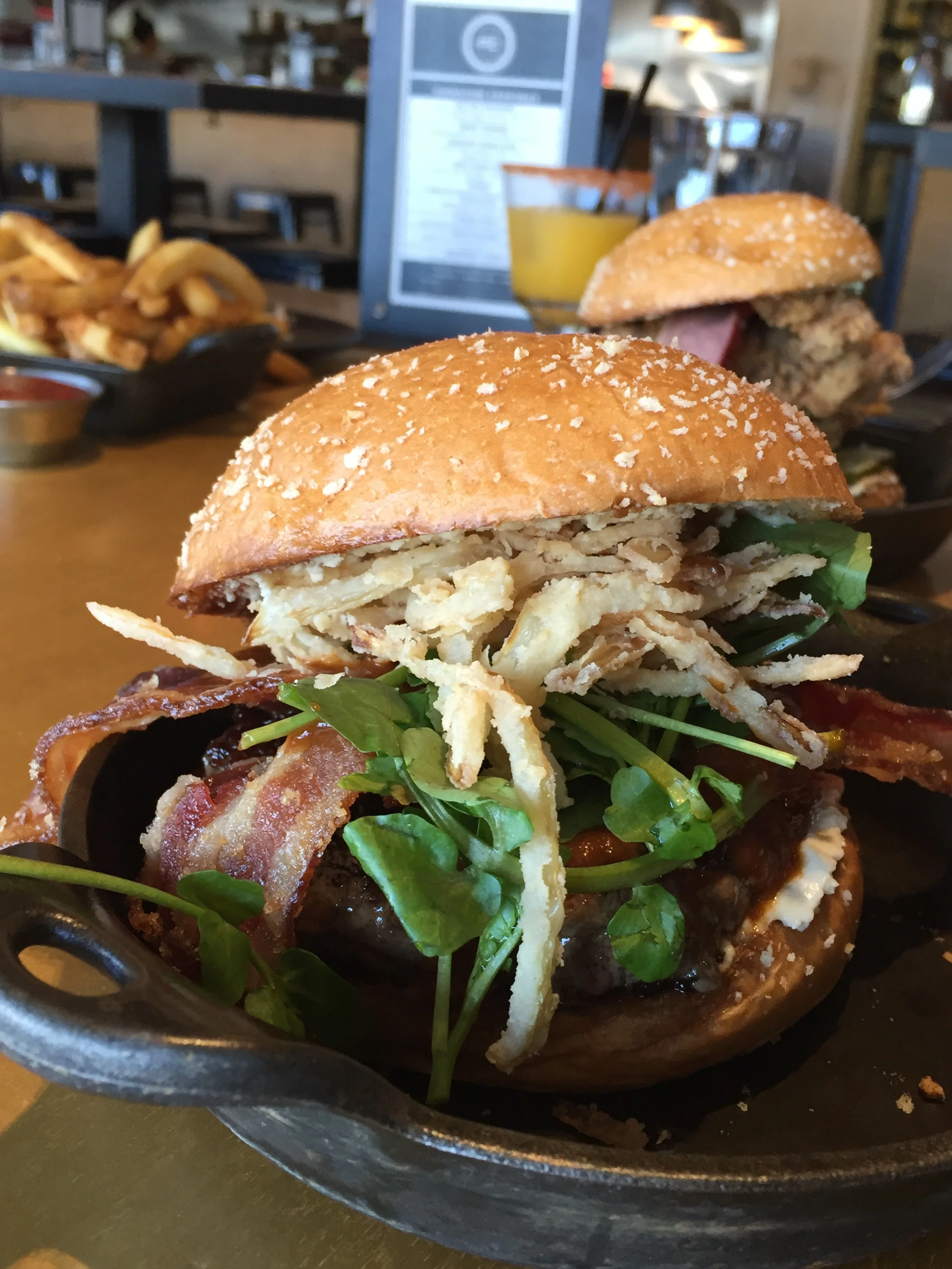 BLEUPRINT BURGER - smoked blue cheese, pig candy, fried onions, roasted garlic steak sauce, peppercress.