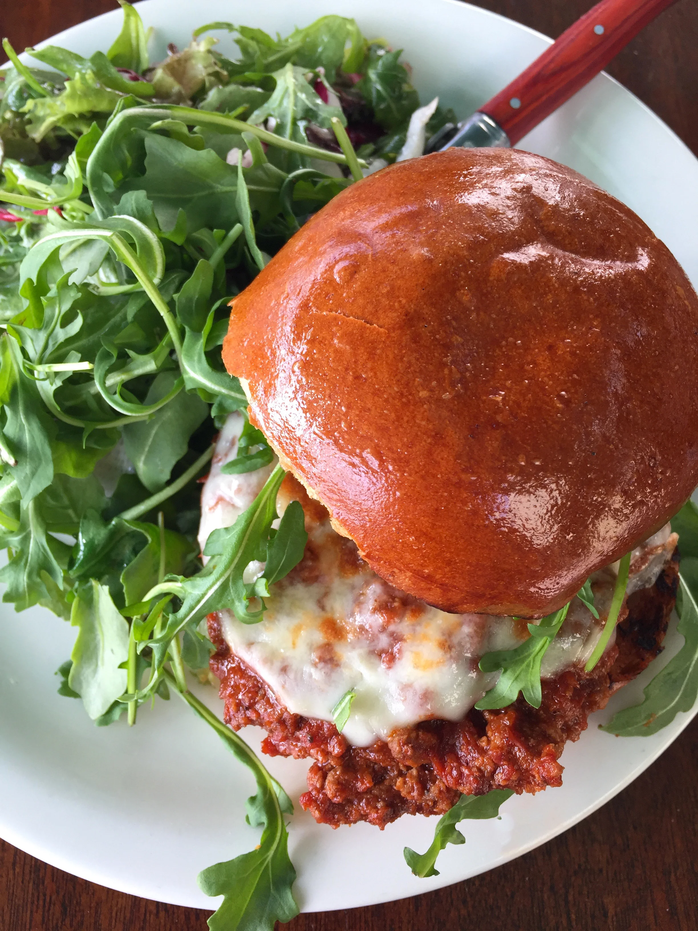Hangover Special with braised lamb, provolone, arugula, and a brioche bun.